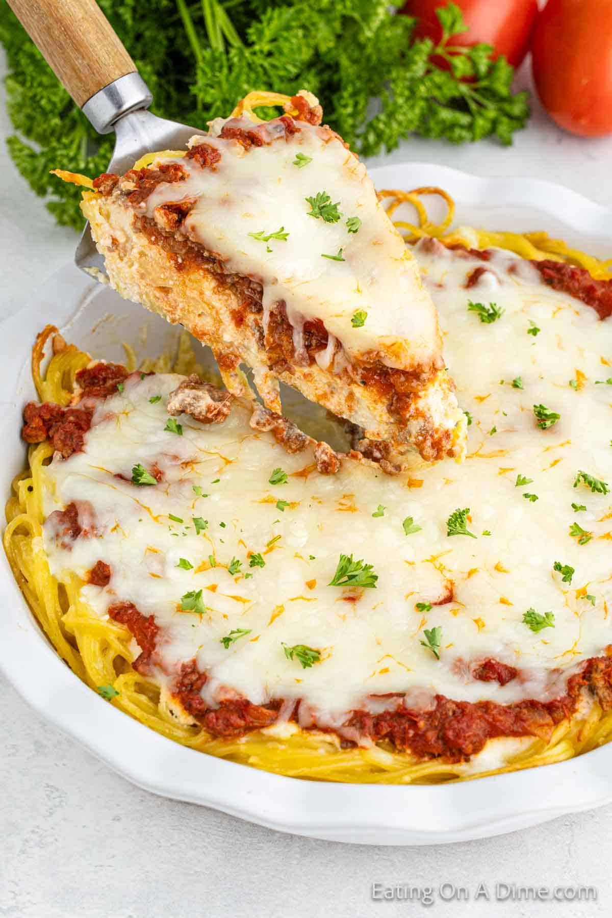 Spaghetti Pie in a pie plate with a serving on a spatula