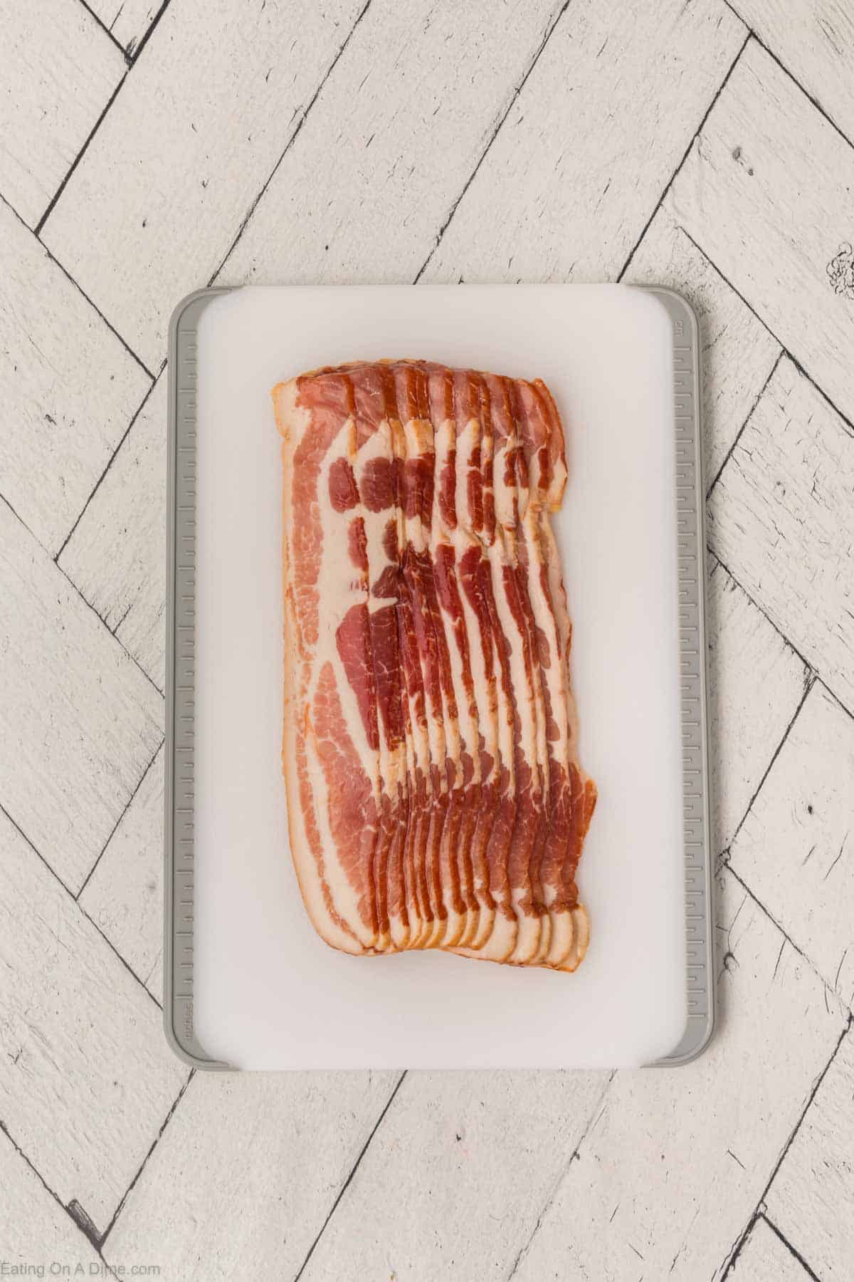 Strips of uncooked bacon