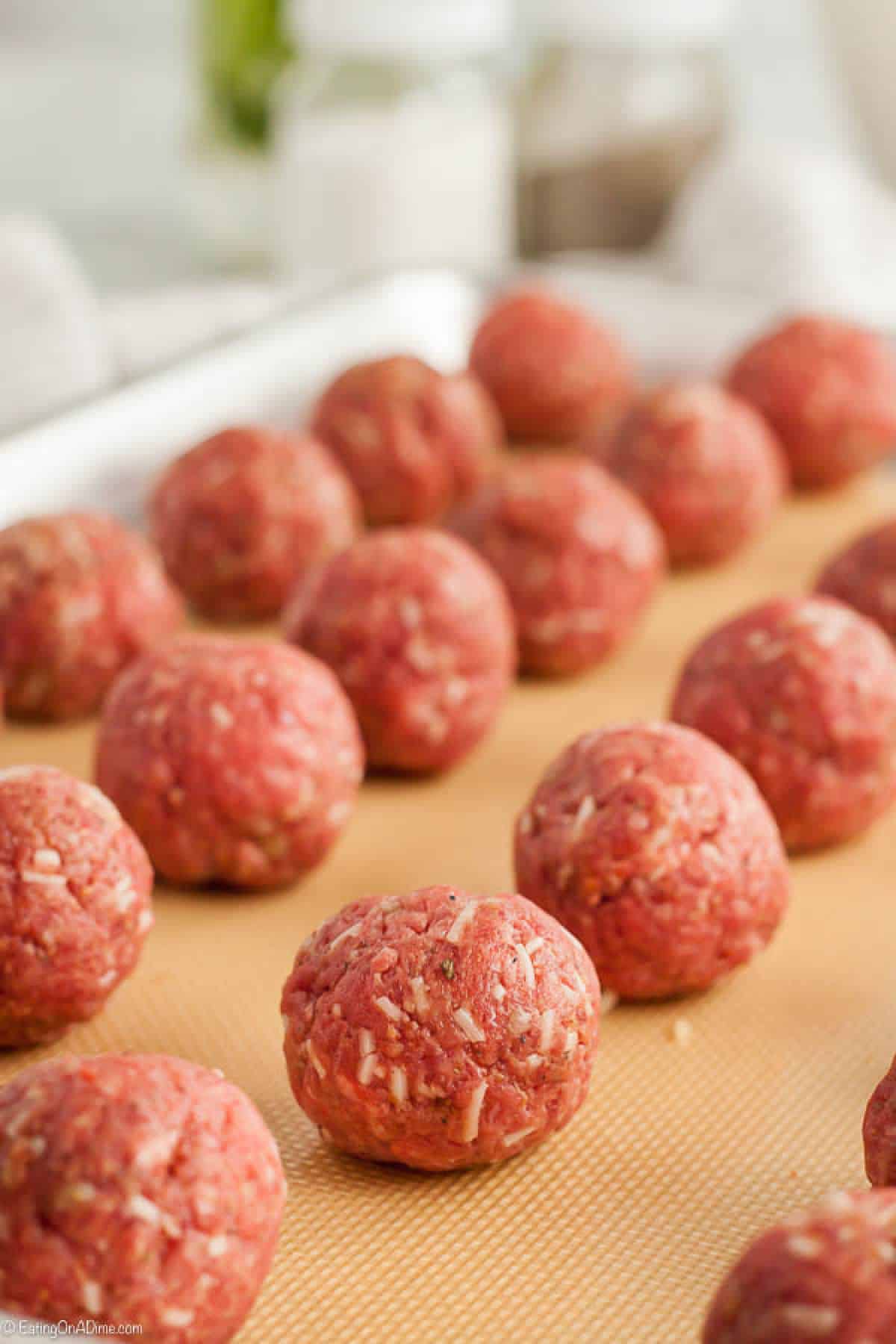 Ground beef meatballs on a baking sheet