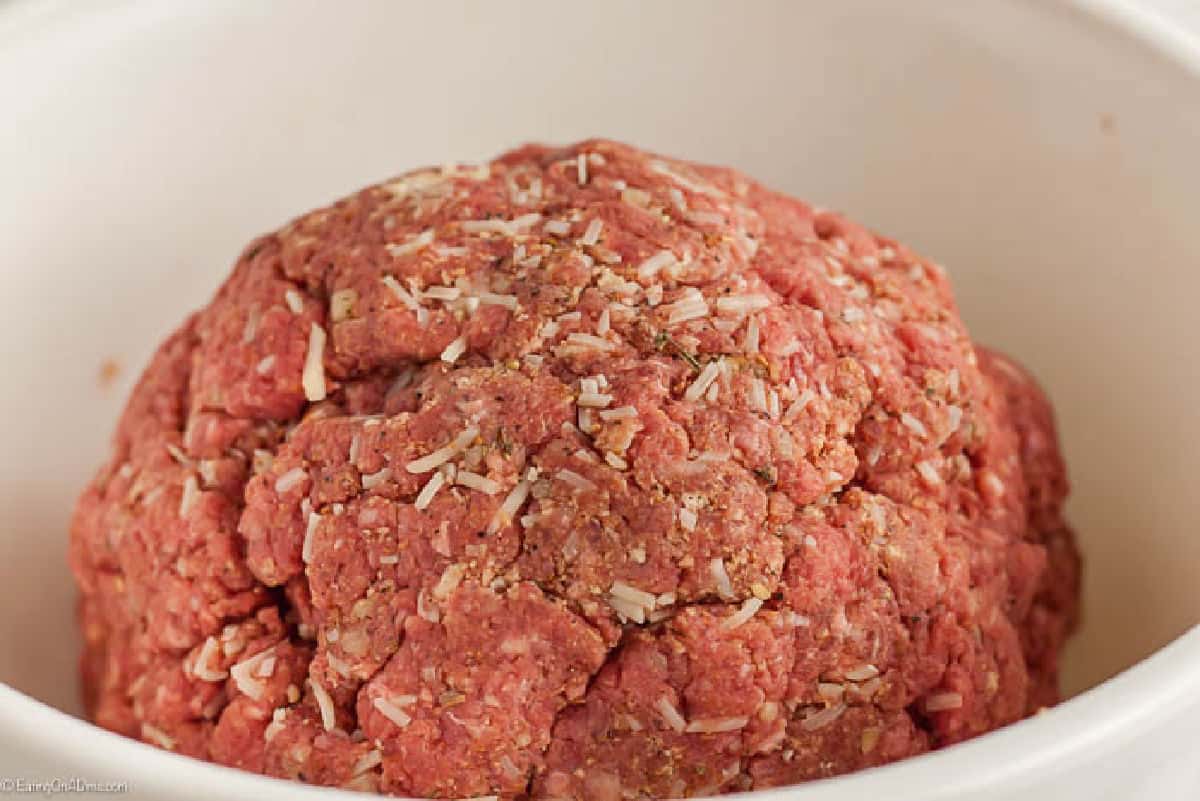 Ground beef in a shape of a ball in a bowl