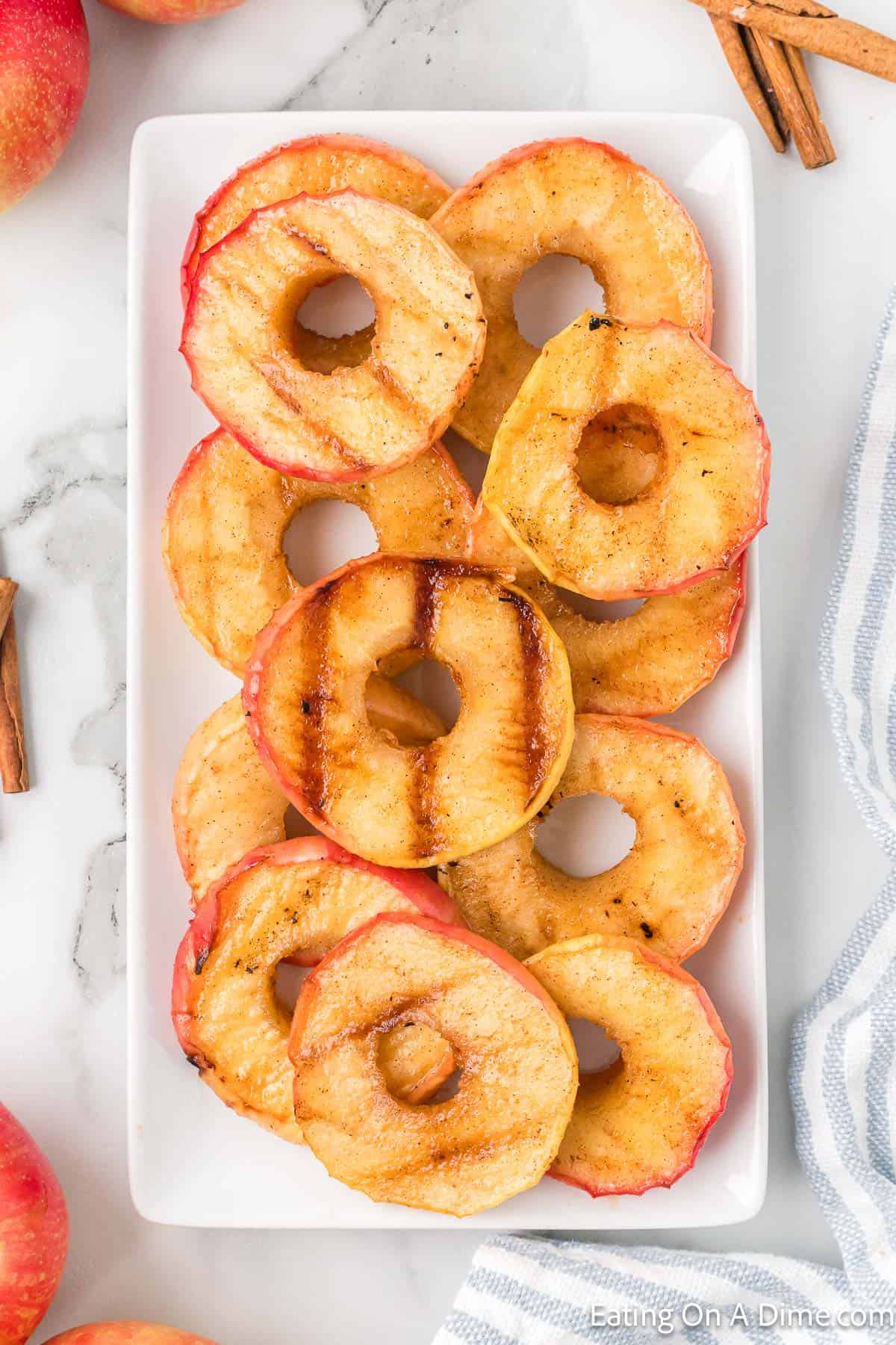 Grilled apples sliced stacked on a platter