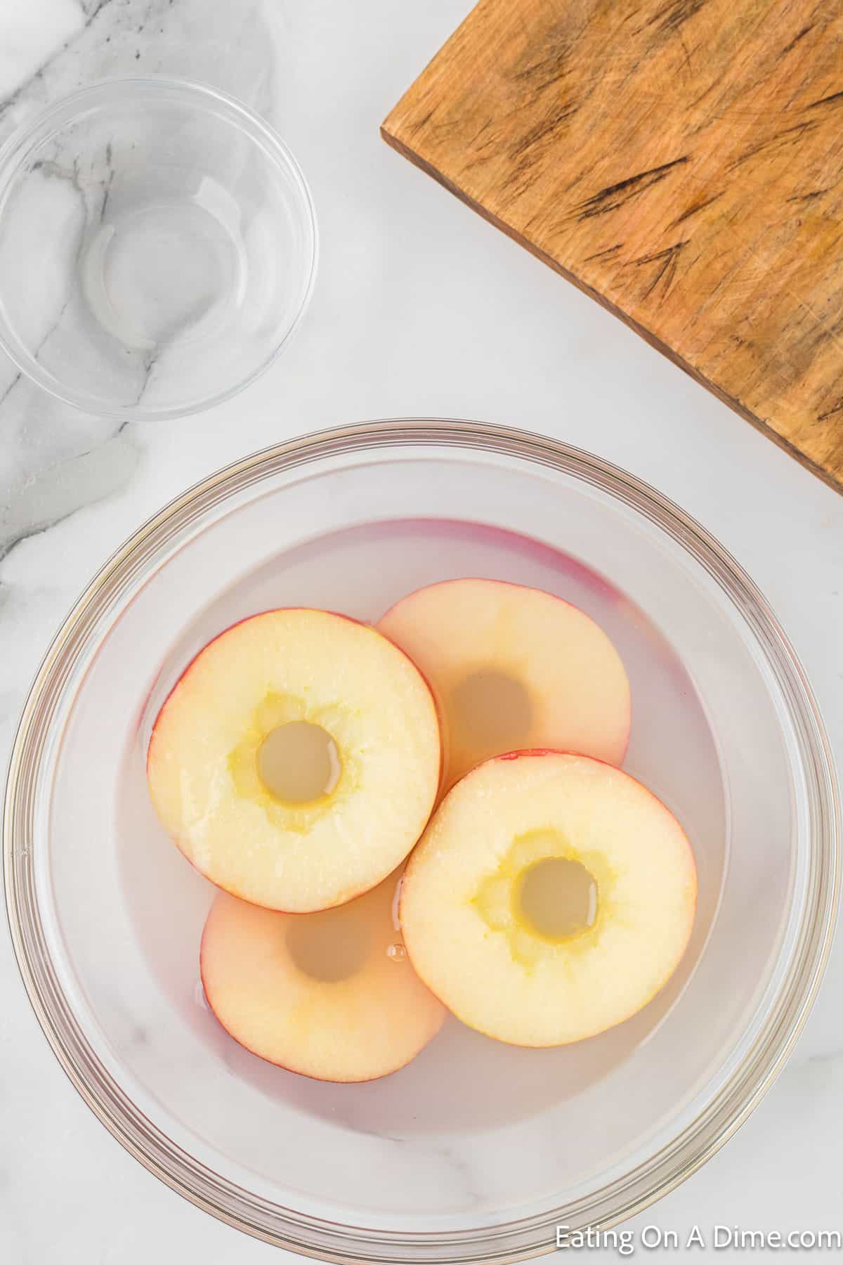 Slice apples in a bowl of water