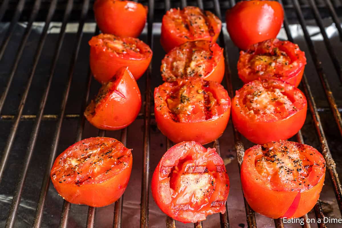Grilled tomato halves on  grill grates