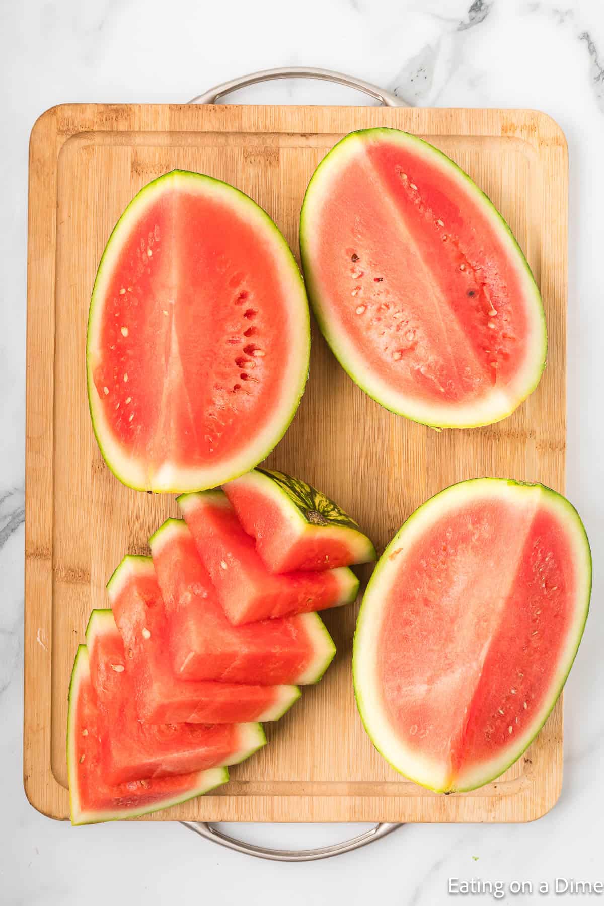 Watermelon cut into halves and then in a triangle shape