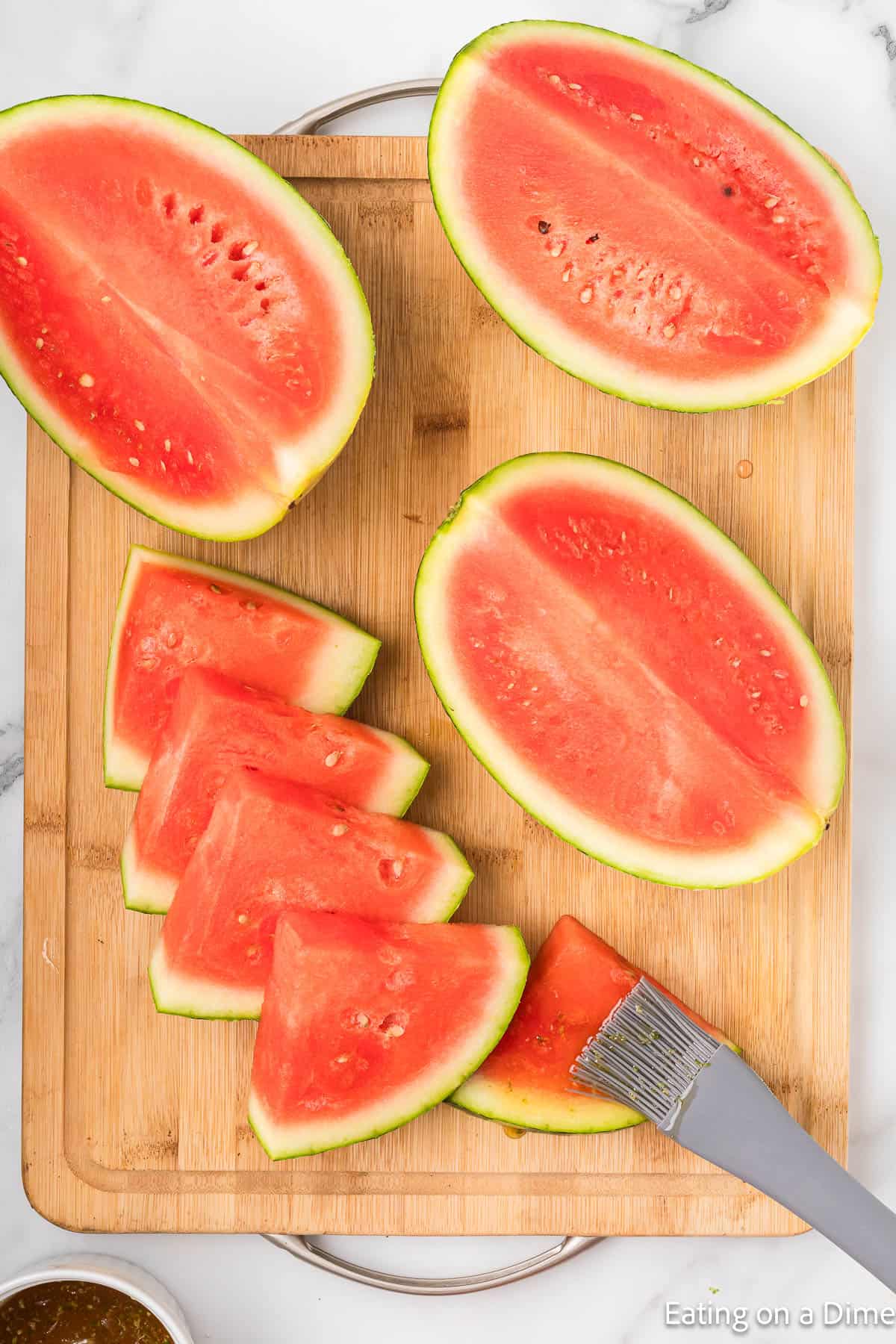 Cut watermelon on a cutting board and then brushed with the lime mixture