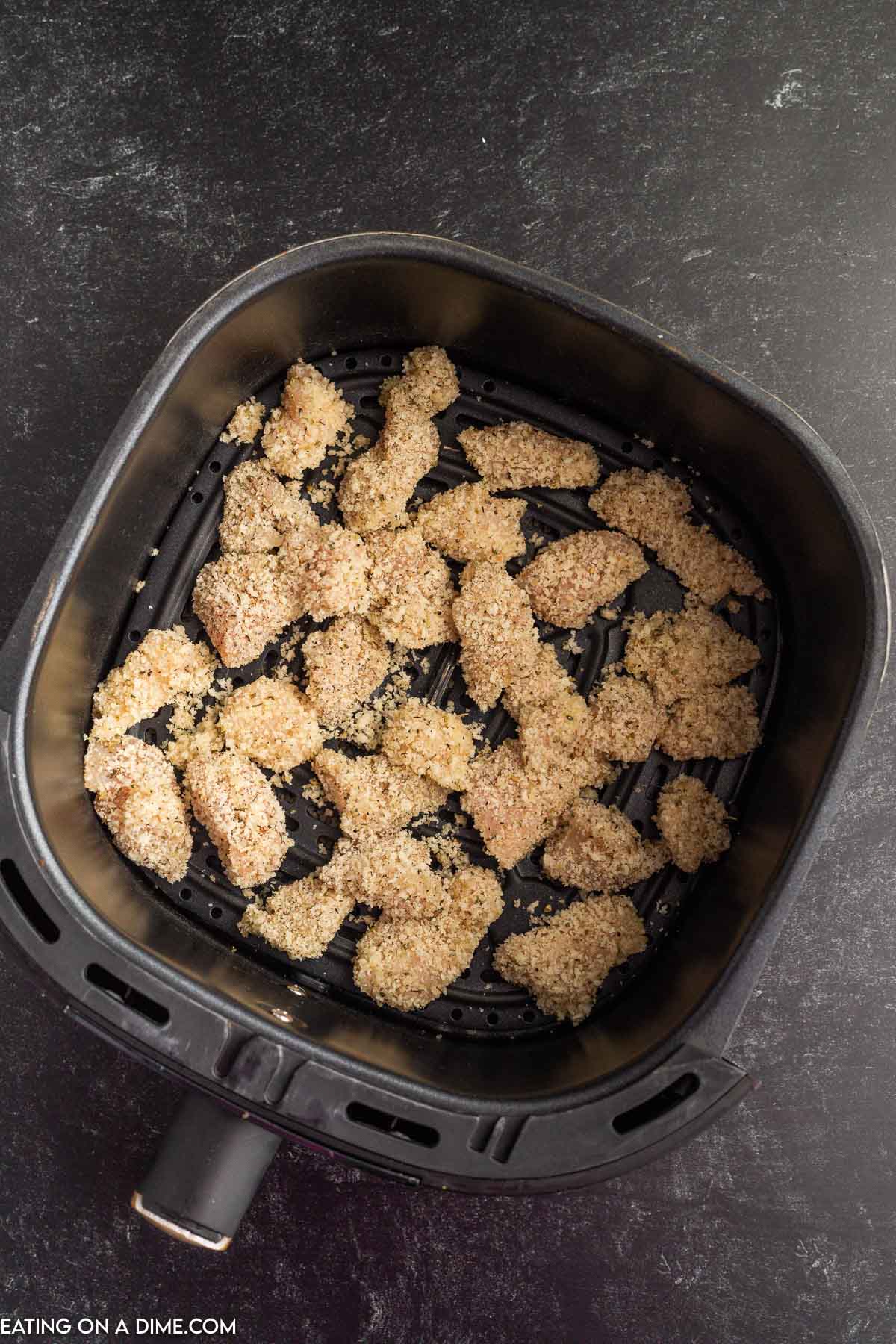 Breadcrumb coated bite size chicken in the air fryer basket