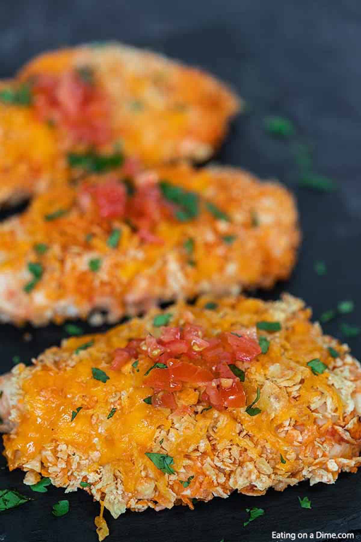 Baked Mexican Chicken topped with melted cheese and diced tomatoes 