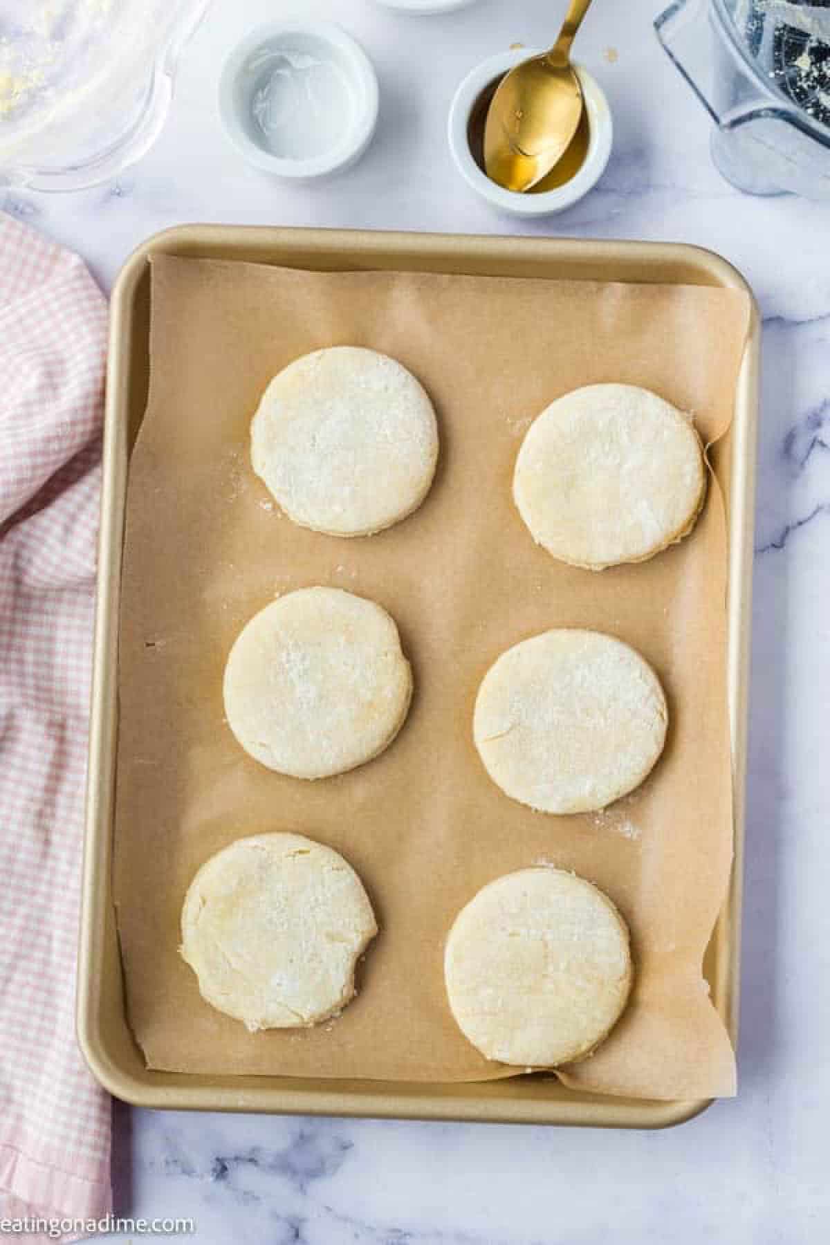 Biscuit dough on a baking sheet lined with parchment paper