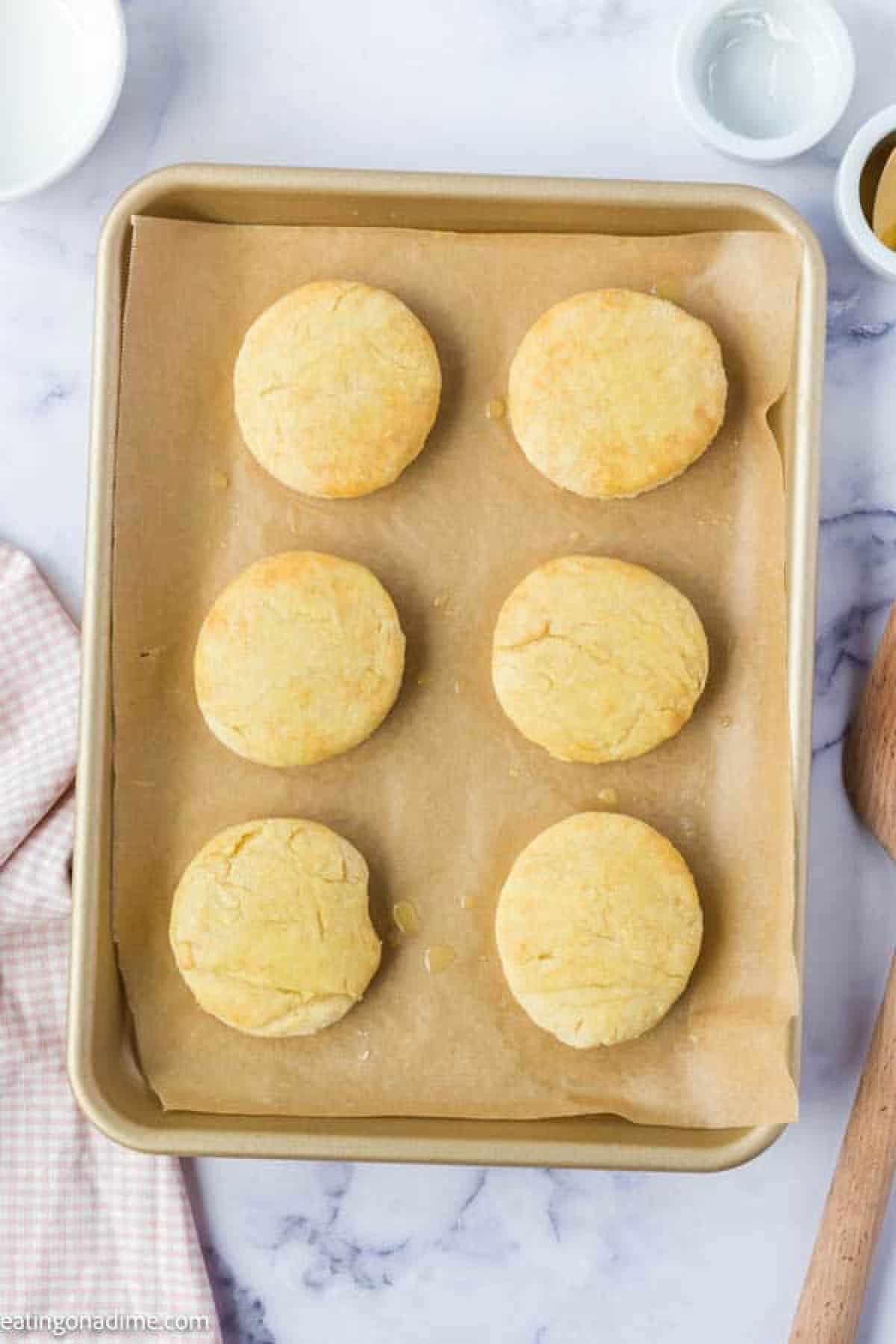 Baked biscuits on a baking sheet with parchment paper