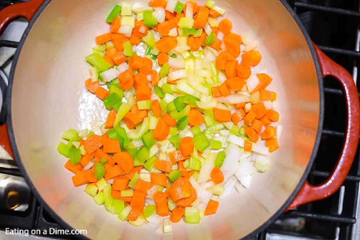 Cooking celery, carrots and onions in a large pot