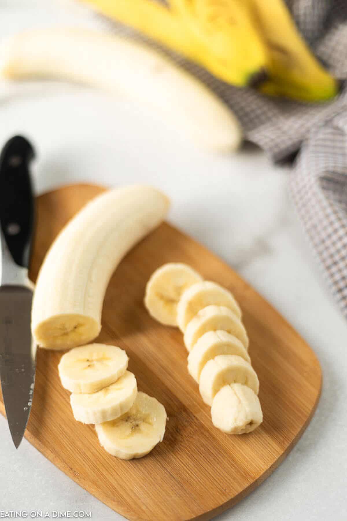 Slice bananas on a cutting board with a knife