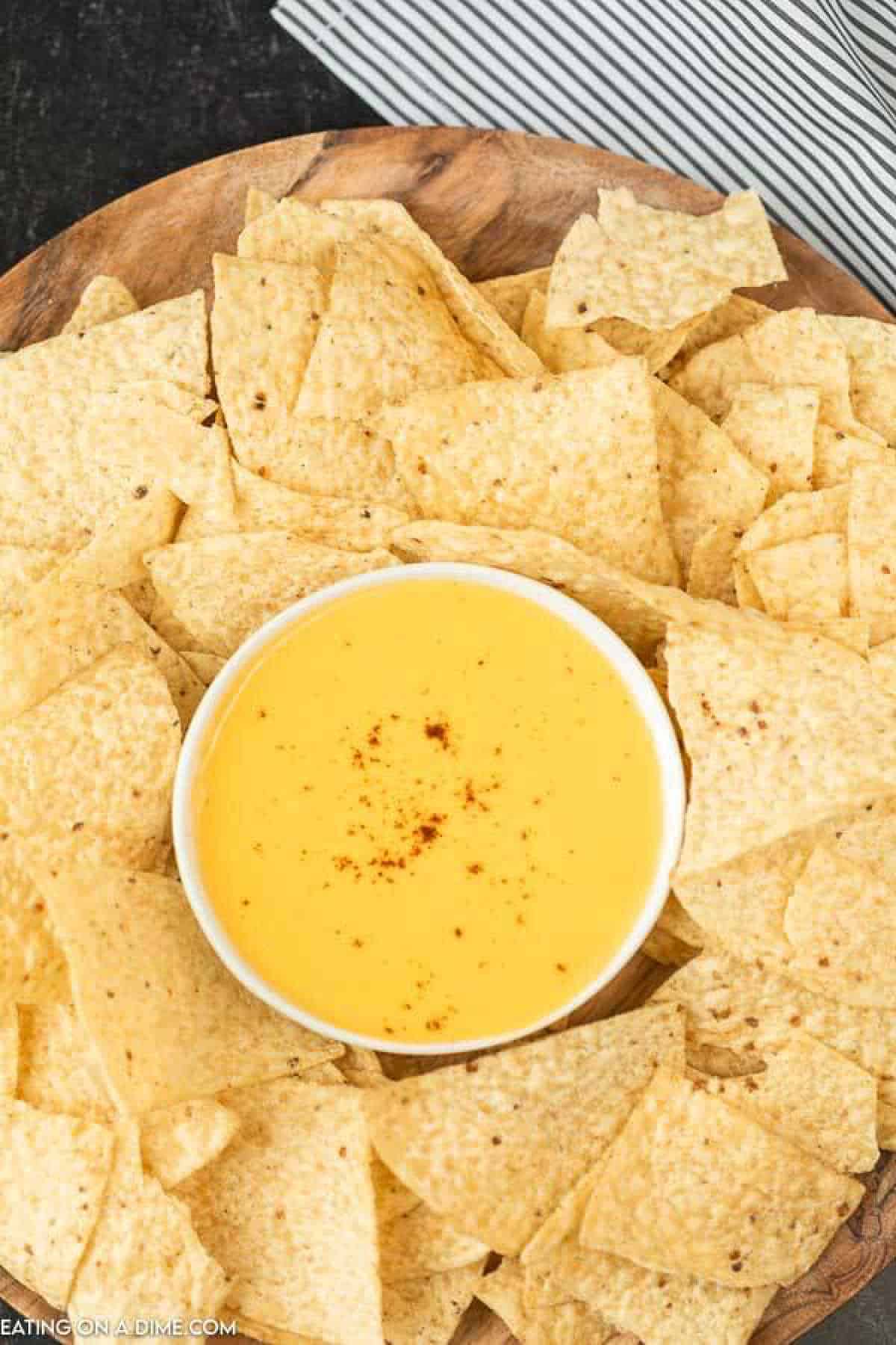 Tortilla chips and nacho cheese dip in a platter