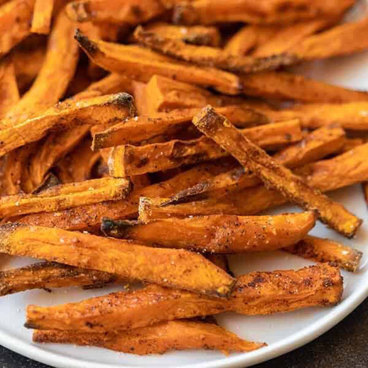 Sweet potato fries stacked on a plate 