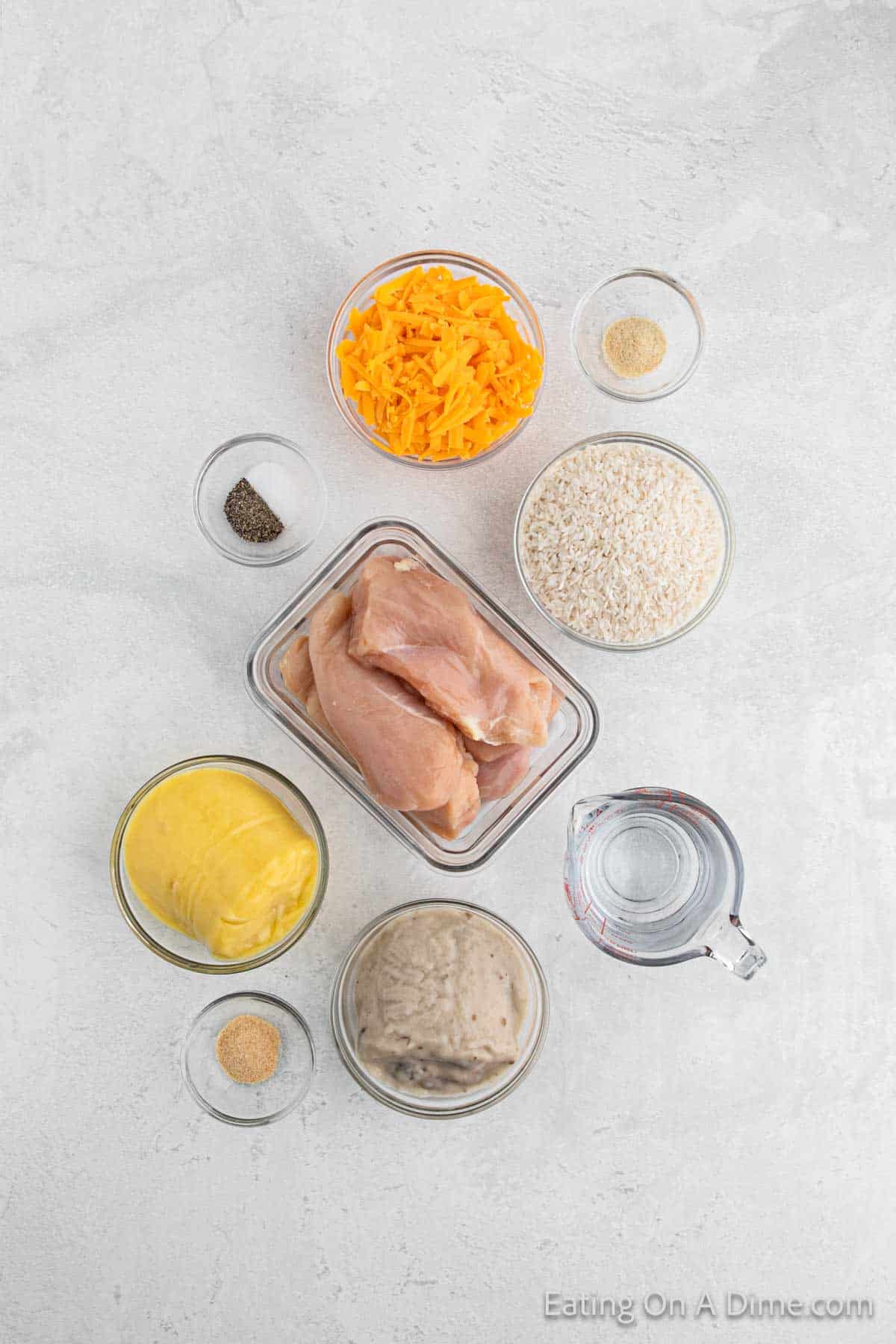 Ingredients - White Rice, cream of chicken soup, cream of mushroom soup, water, salt, garlic powder, onion powder, pepper, chicken breasts, cheddar cheese