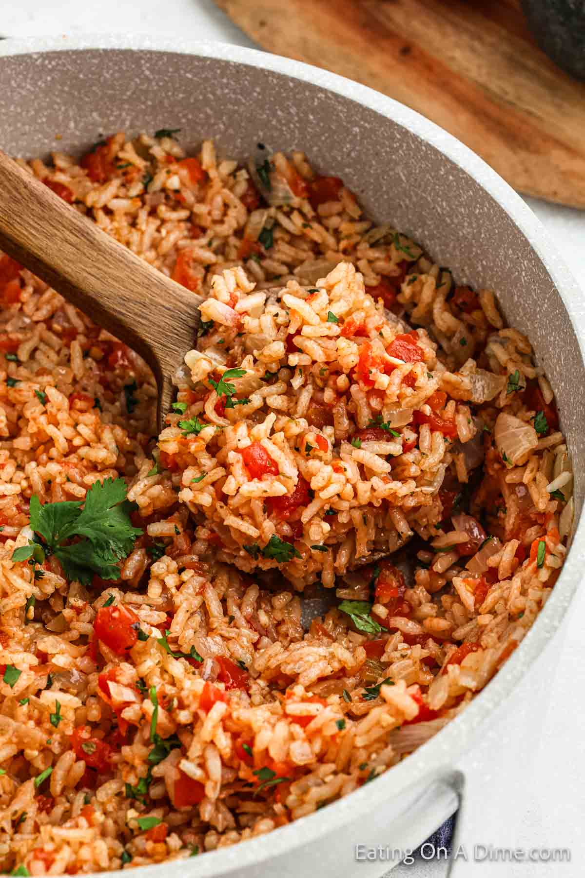 Mexican Rice in a serving dish with a wooden spoon