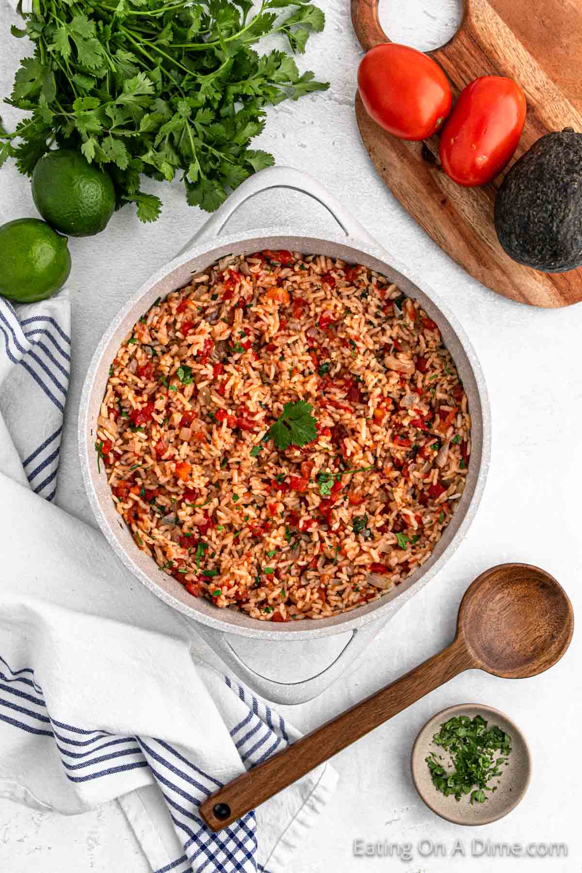 Mexican Rice in a large pot with a wooden spoon on the side