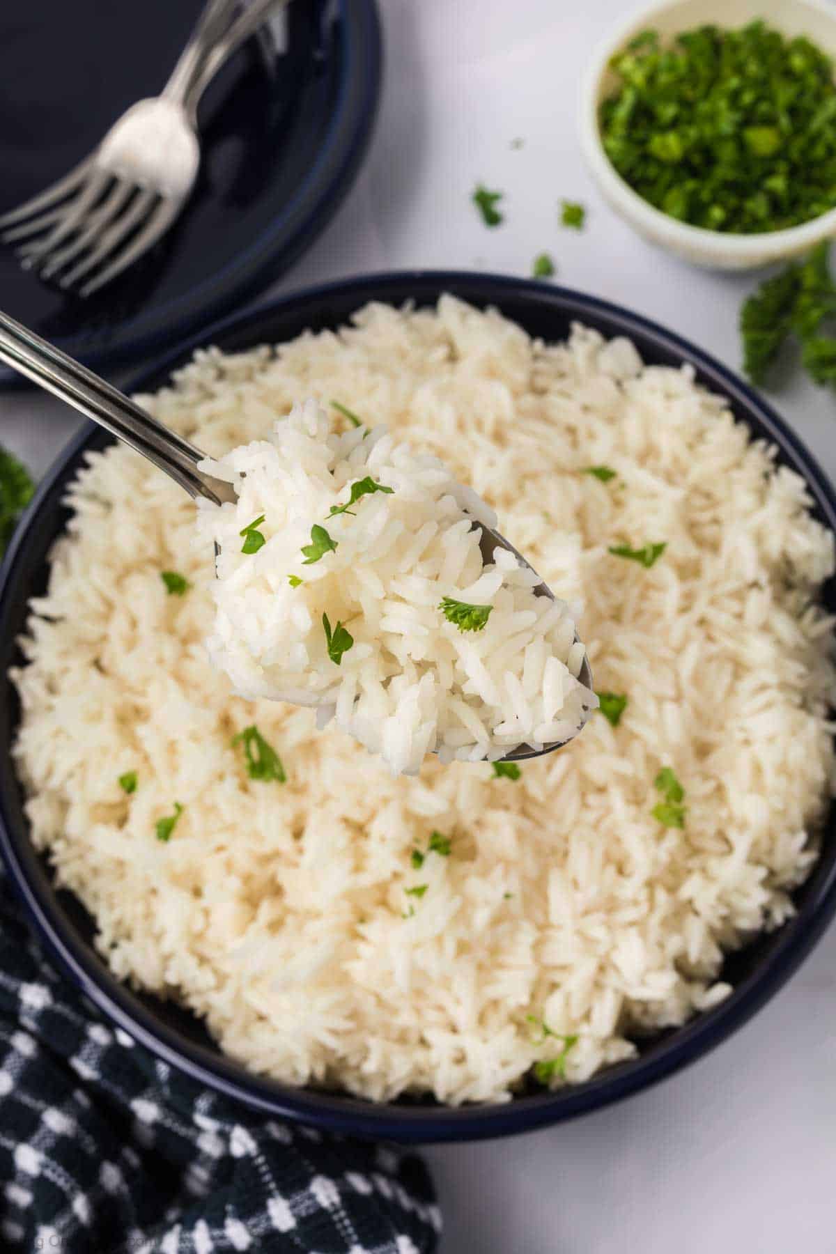 Jasmine Rice in a large bowl with a serving on a spoon