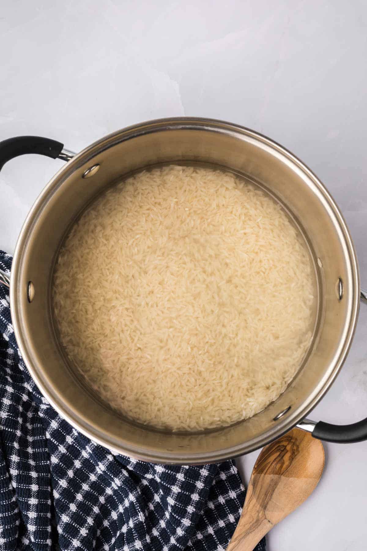 Uncooked rice in a large sauce pan with water