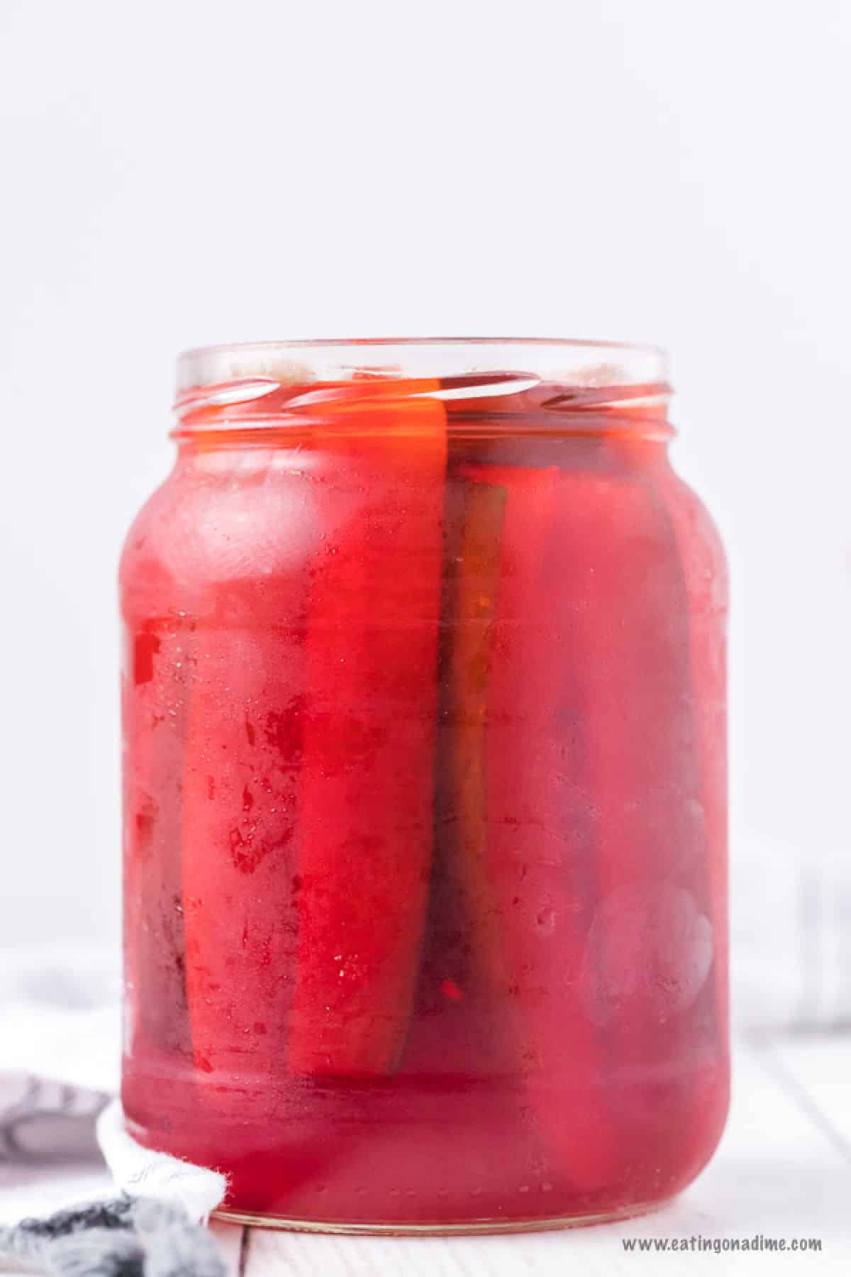 Jar of pickles in a red kool aid