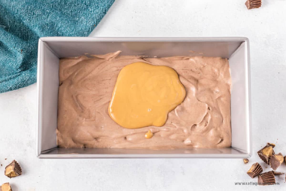 Chocolate mixture poured into the loaf pan topped with melted peanut butter