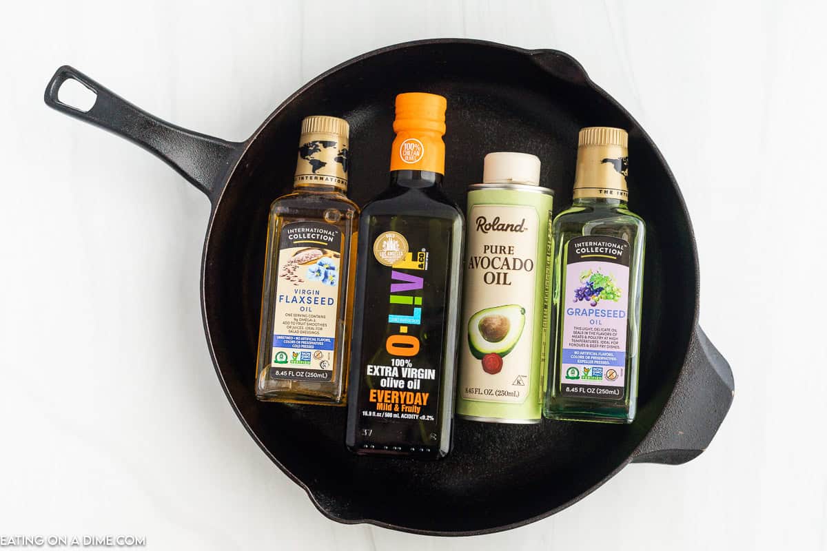 Flaxseed oil, olive oil, avocado oil and grapeseed oil in a cast iron skillet
