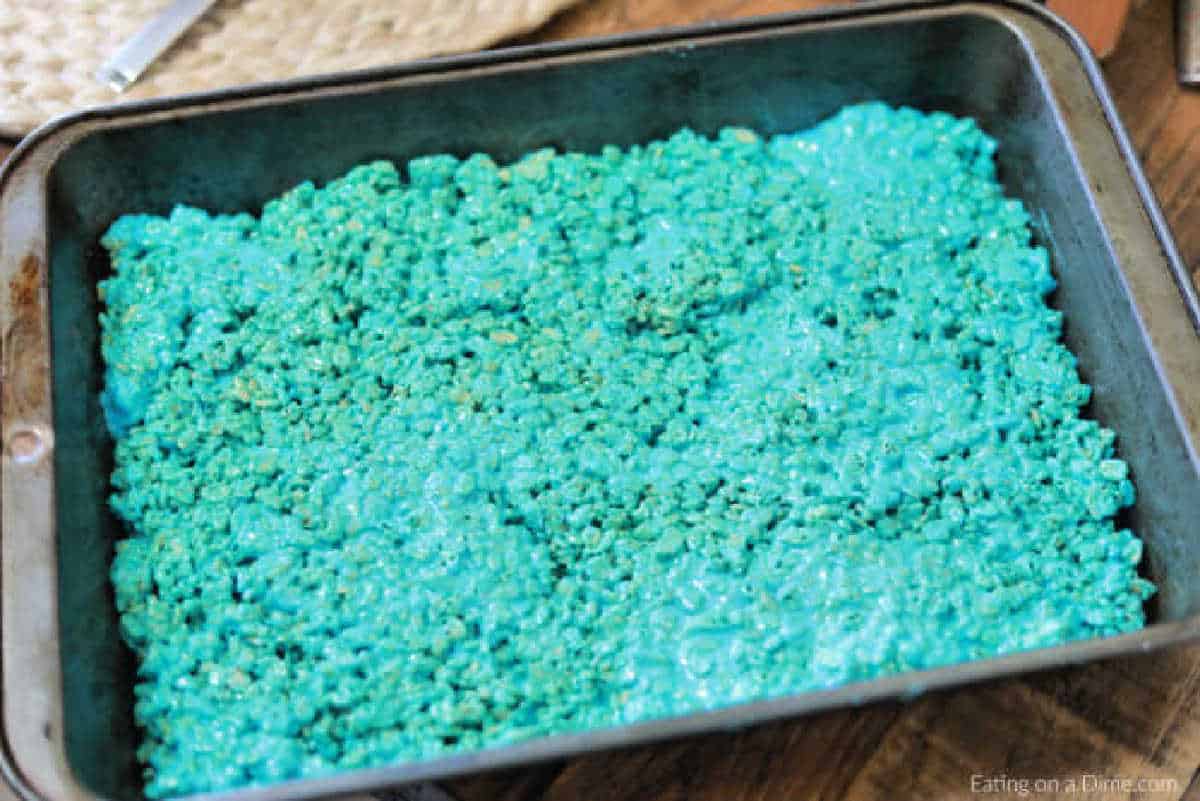 Blue Rice Krispie Treats spread into baking dish