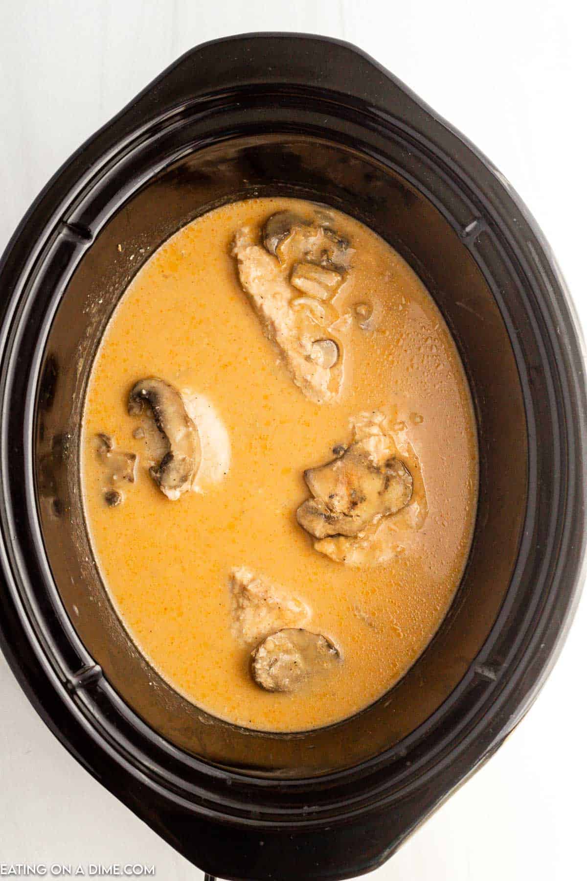 Pork chops and mushrooms in the slow cooker in a creamy broth