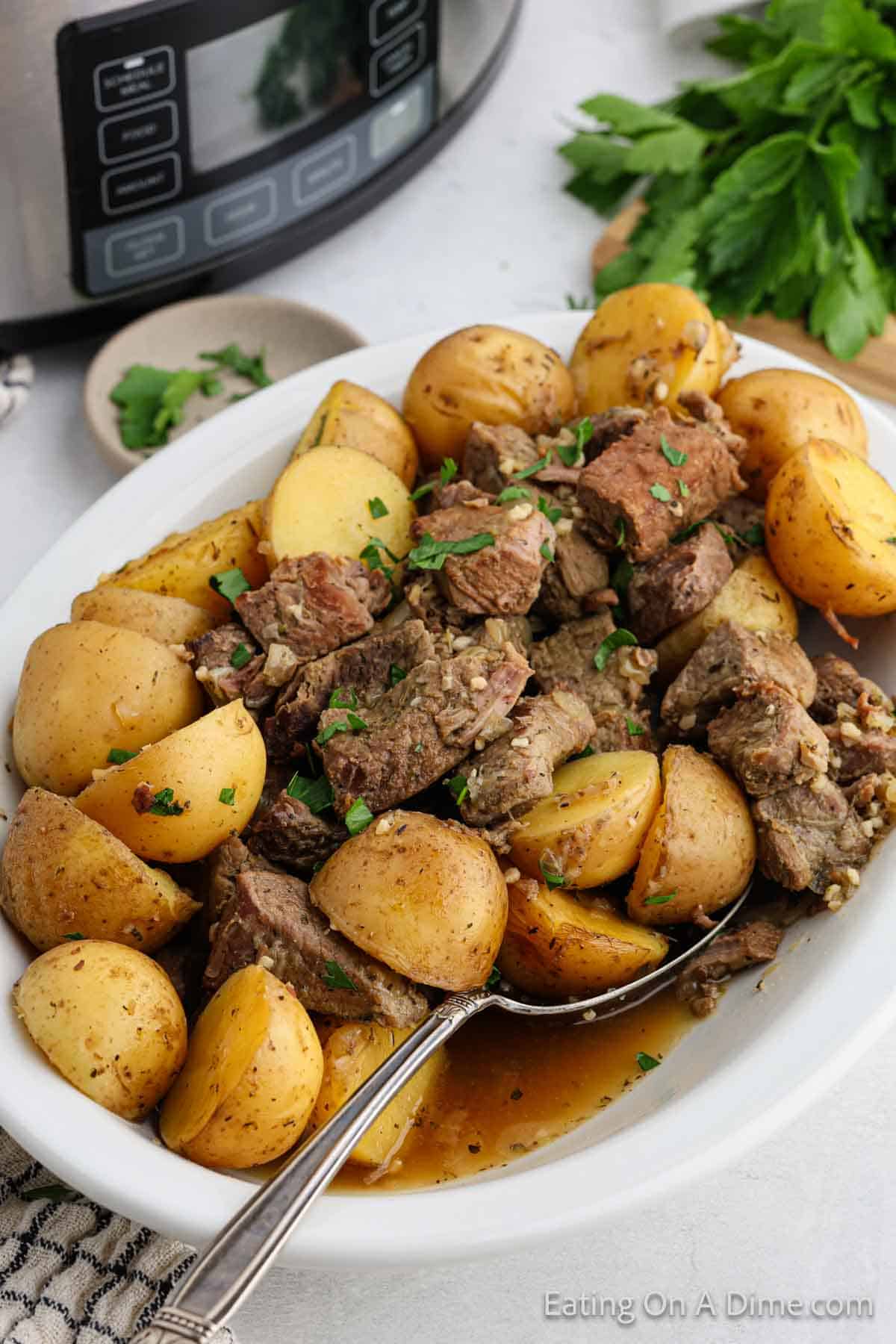 Steak bites on a platter with yellow gold potatoes