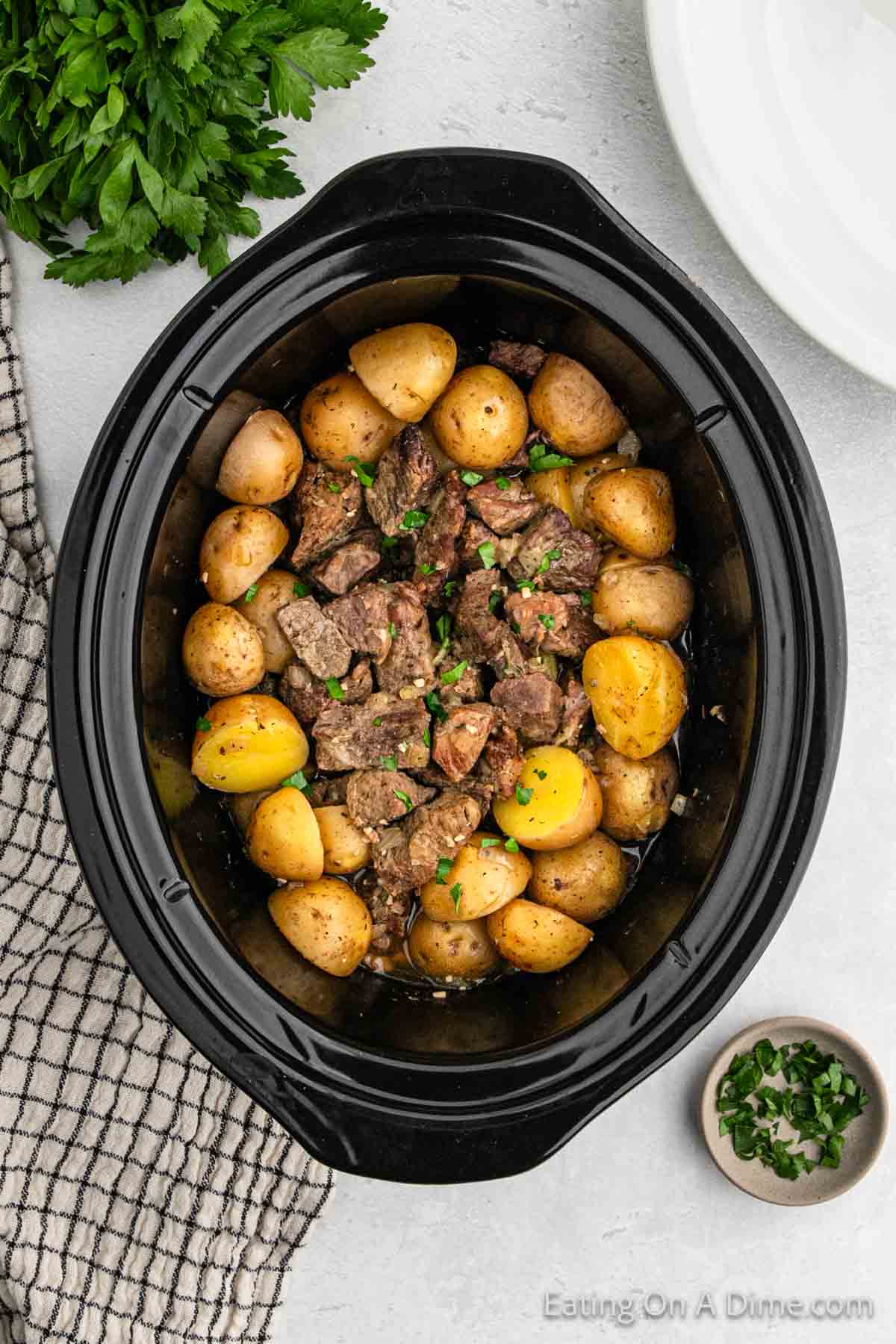 Cooked Steak bites and yellow gold potatoes in the slow cooker