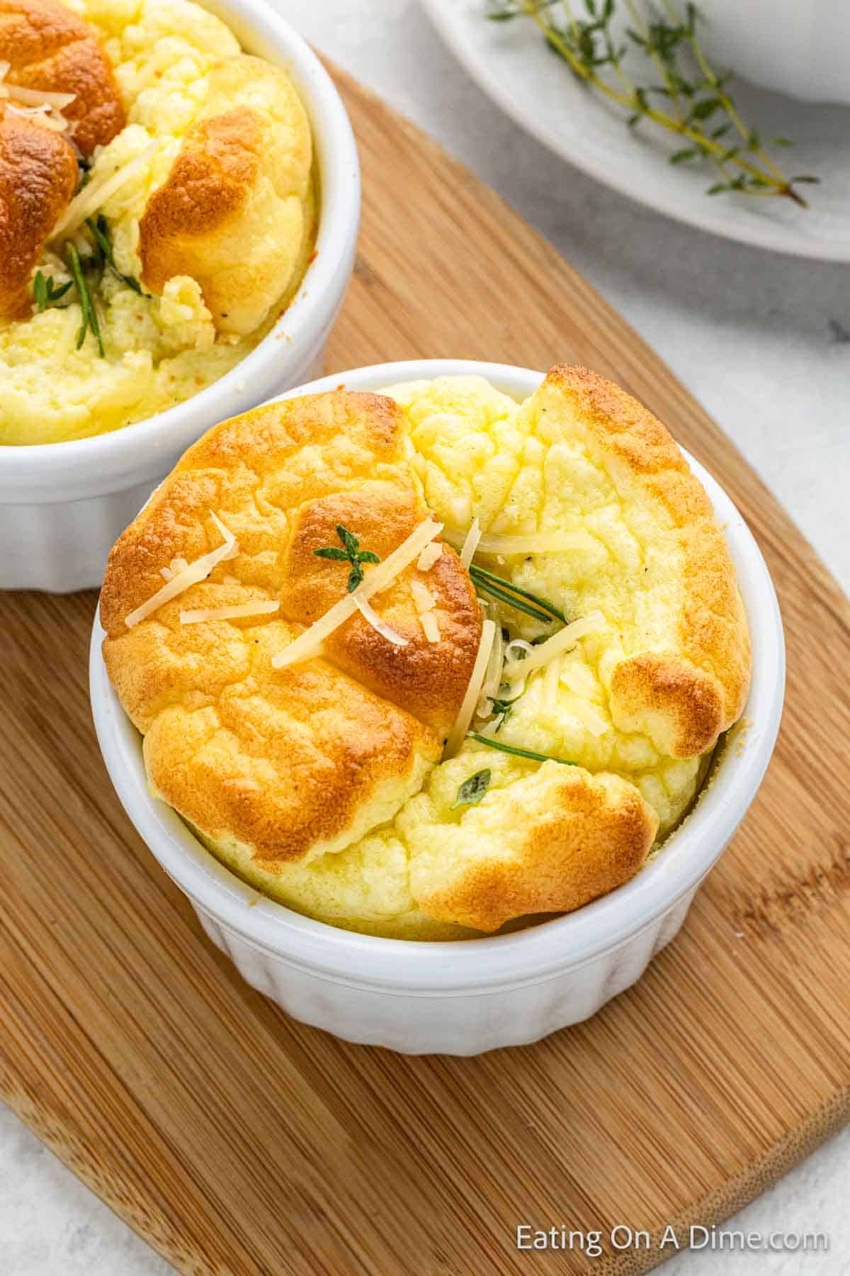 Individual Servings of Egg Souffle in a white baking dish on a brown platter