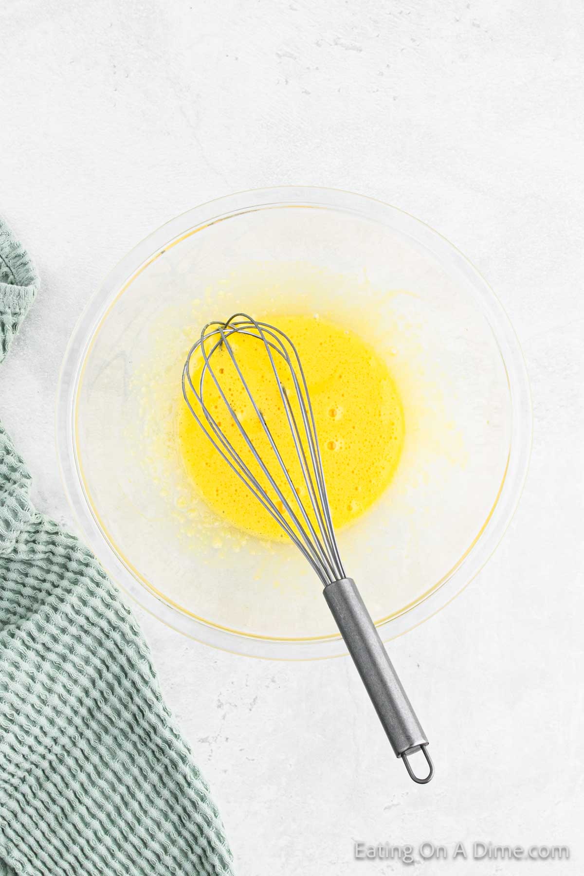 Whisk the egg yolks in a large bowl with a whisk