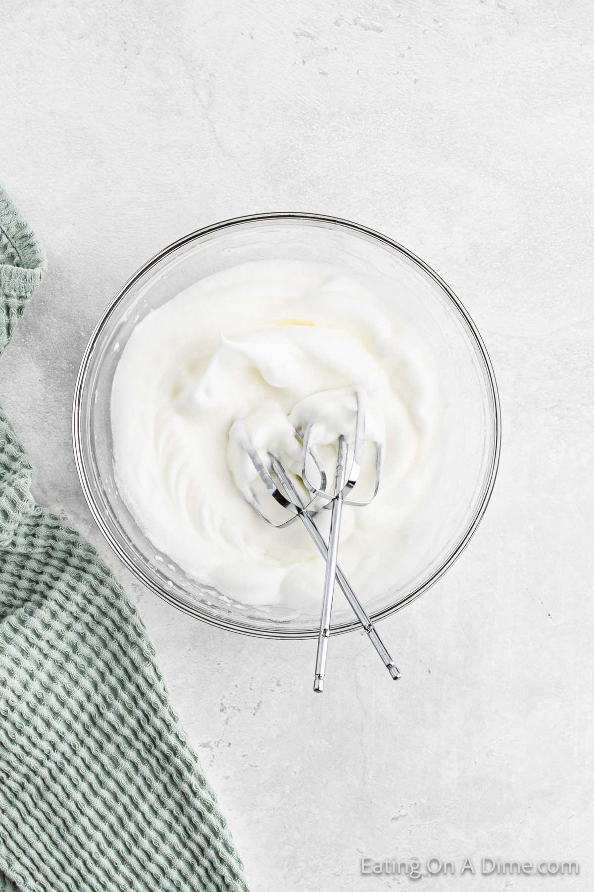 Beating the egg whites in a bowl with a hand mixer 