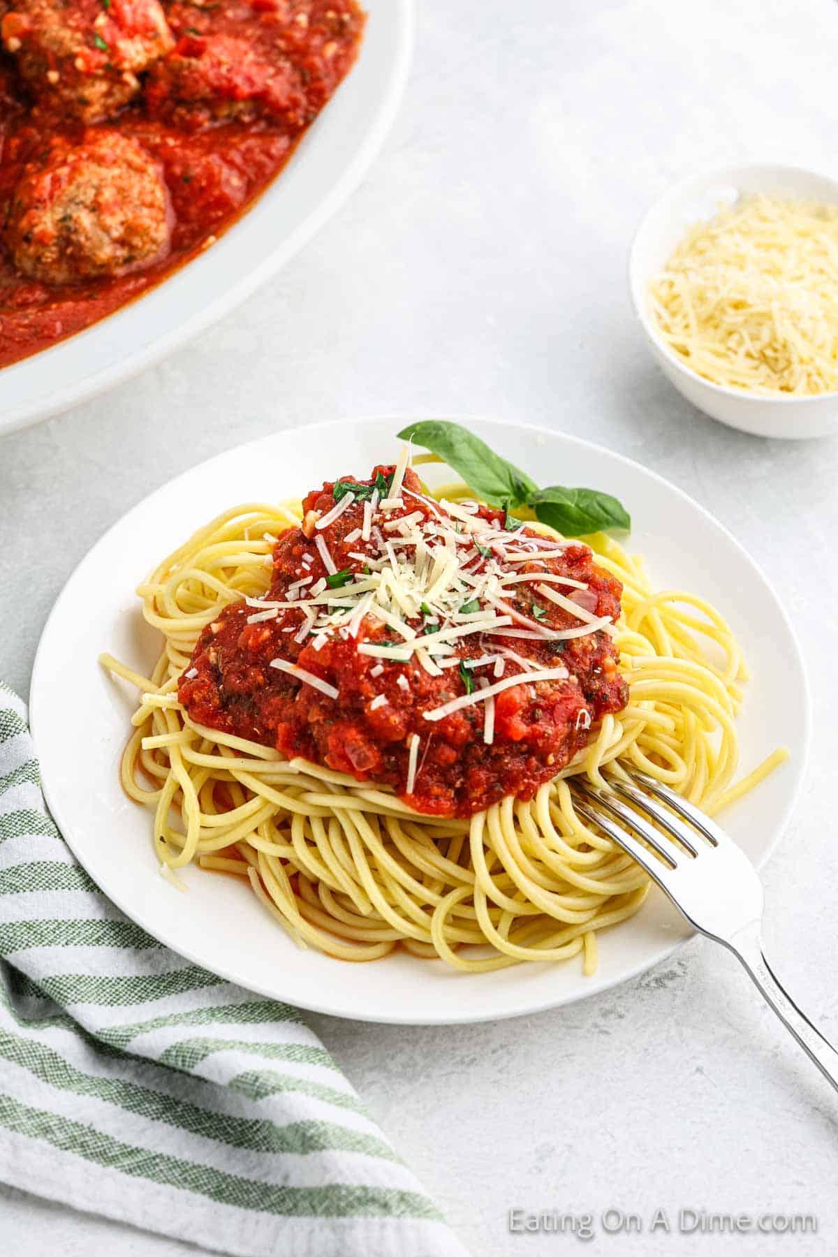 Meatballs and sauce on a plate of spaghetti noodles on a plate