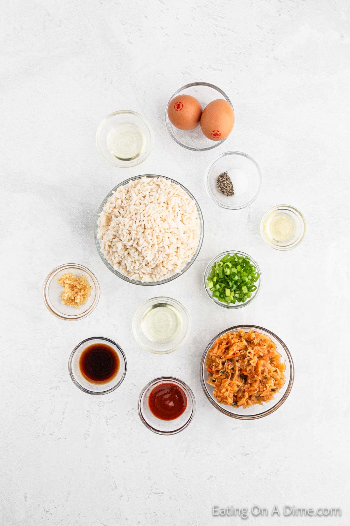 Ingredients - White Rice, kimchi, oil, cloves garlic, sriracha sauce, soy sauce, sesame oil, green onions, eggs, salt, pepper