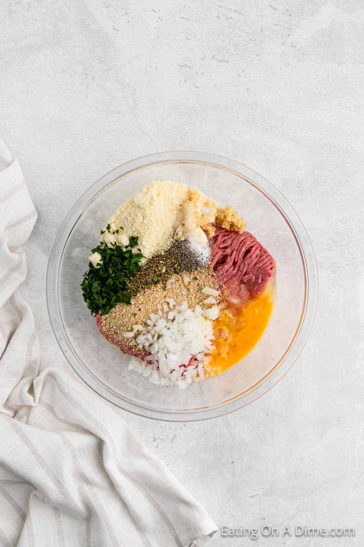 Combining the ground turkey with the breadcrumbs and spices in a bowl