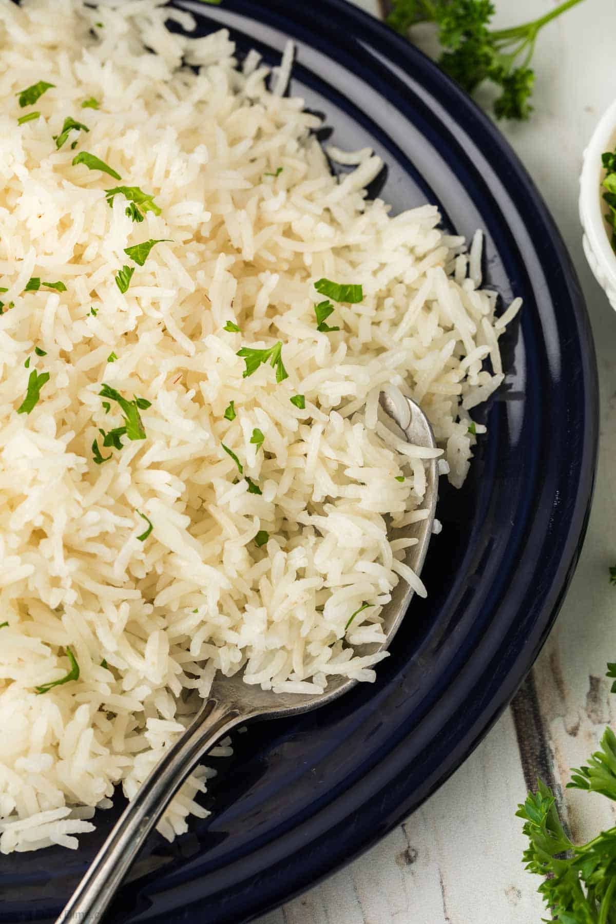 Basmati Rice on a blue plate with a serving spoon