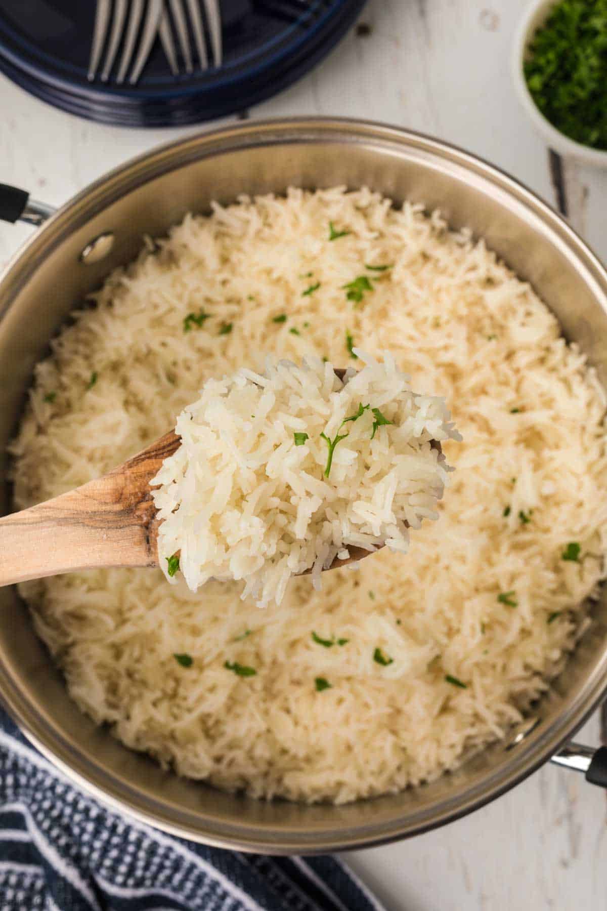 Basmati Rice in a large pot with a serving on a wooden spoon