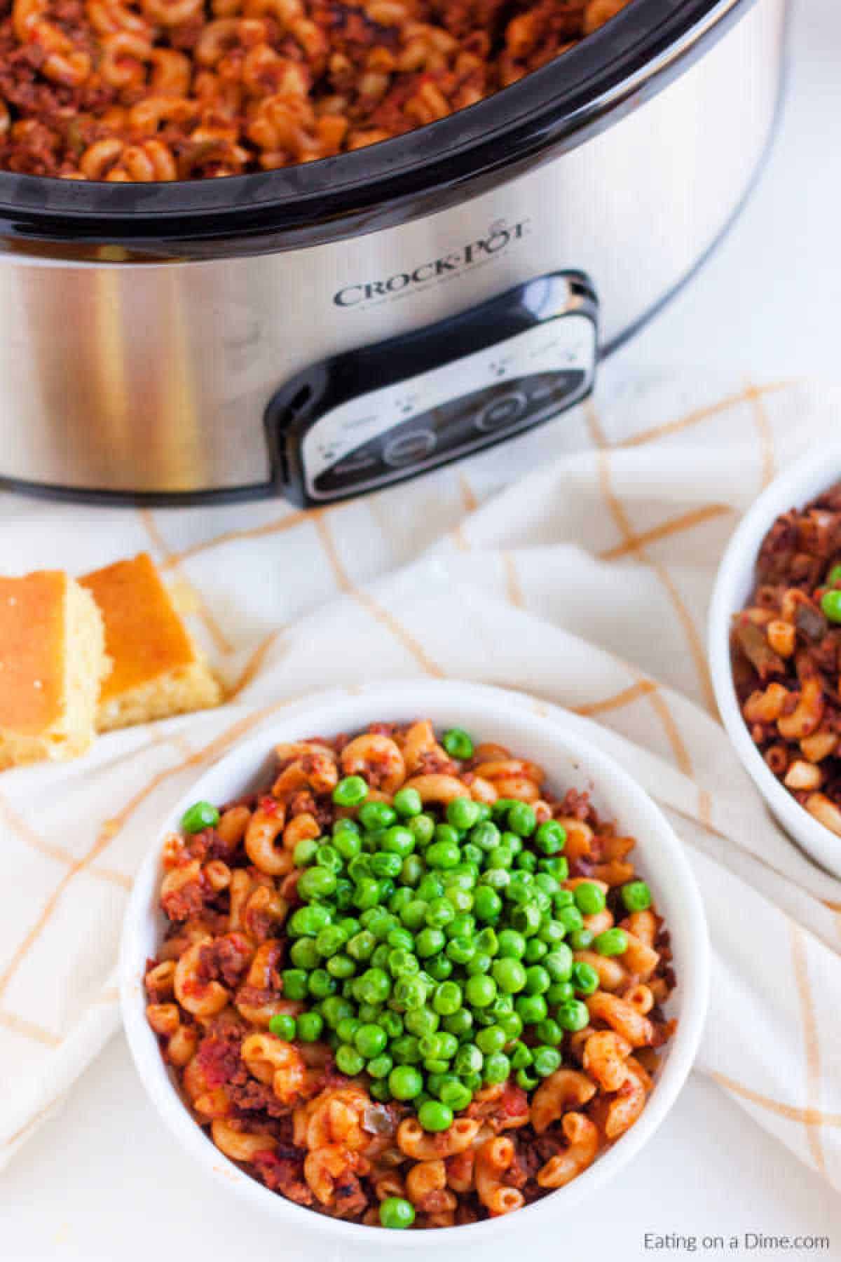 American Goulash topped with peas in a bowl