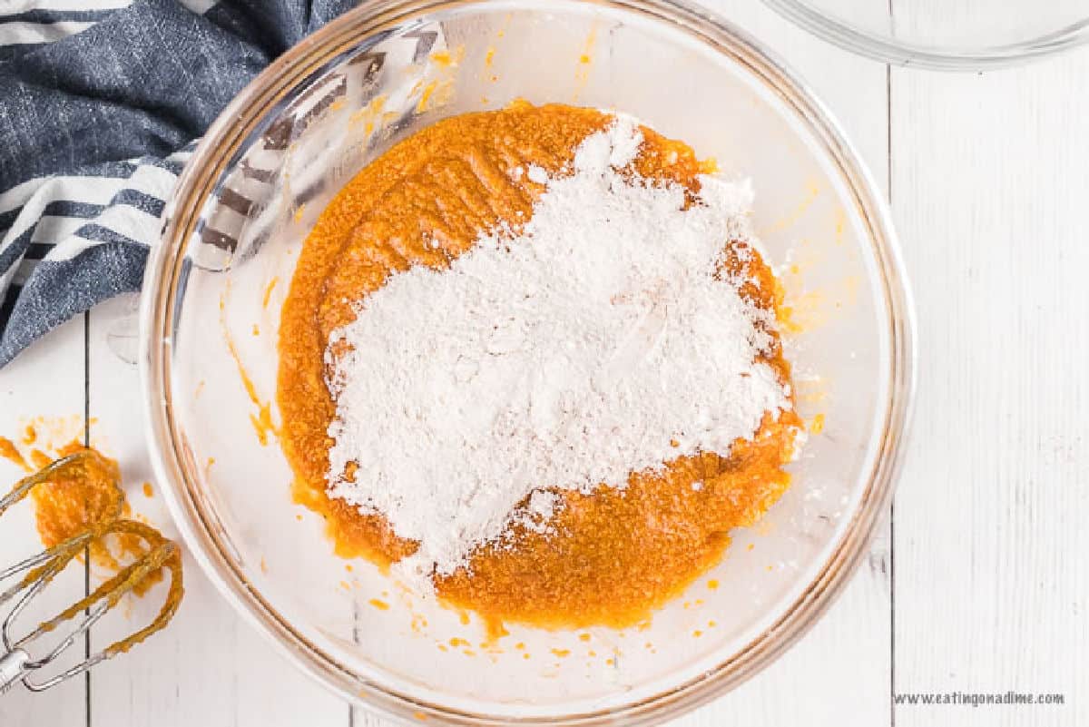 Pumpkin puree in a bowl topped with flour