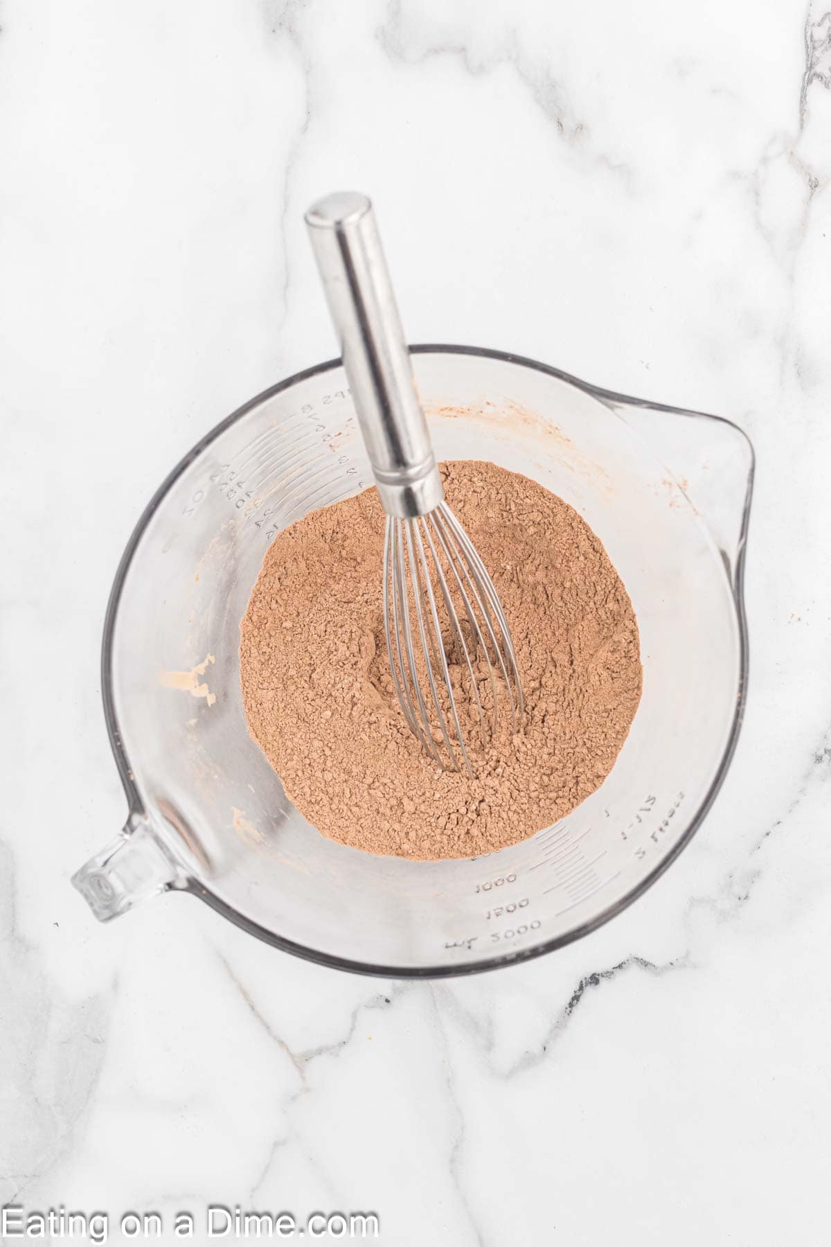 Cocoa powder, baking soda, salt, mixed with a whisk in a bowl