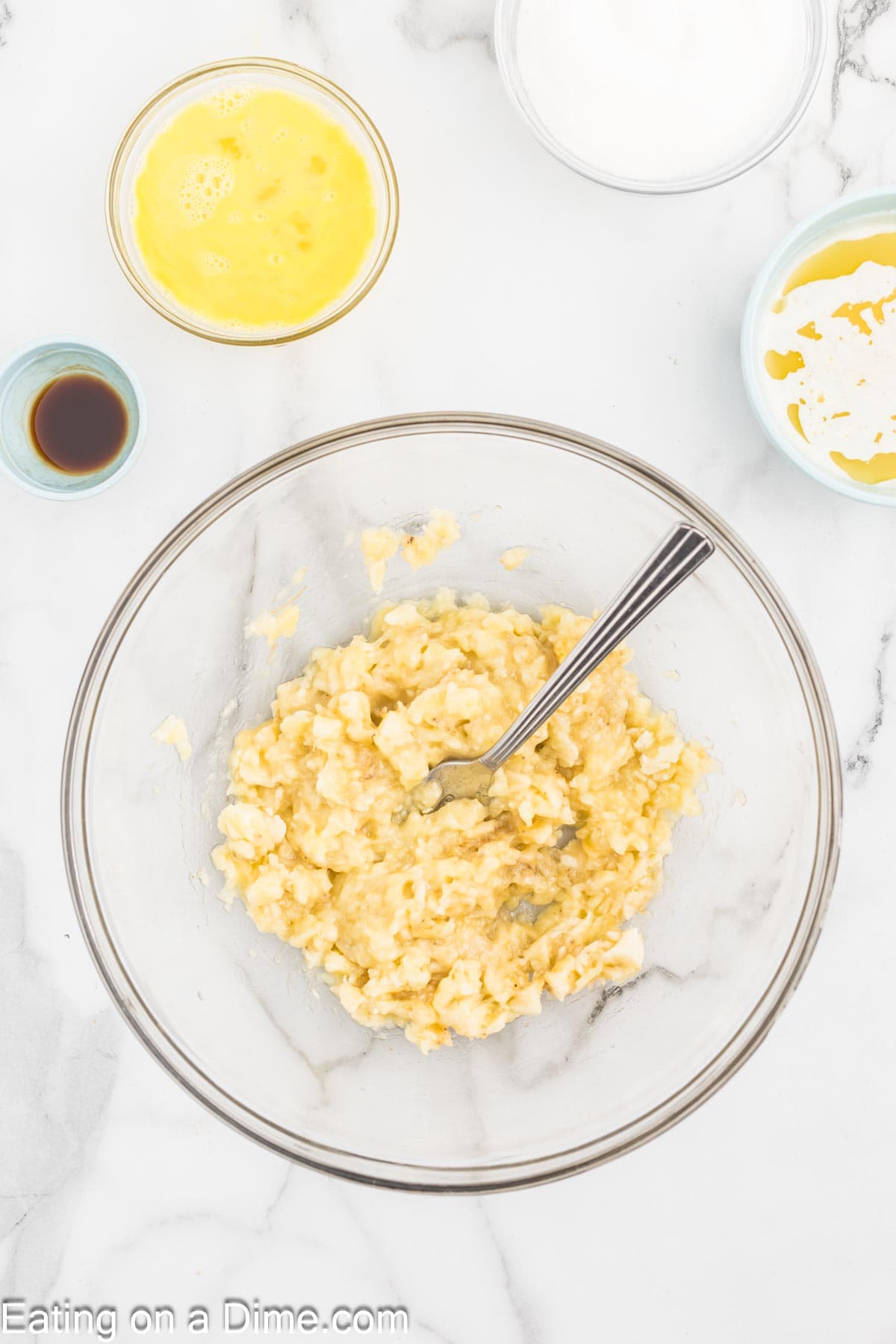 Mashing bananas in a bowl with a fork