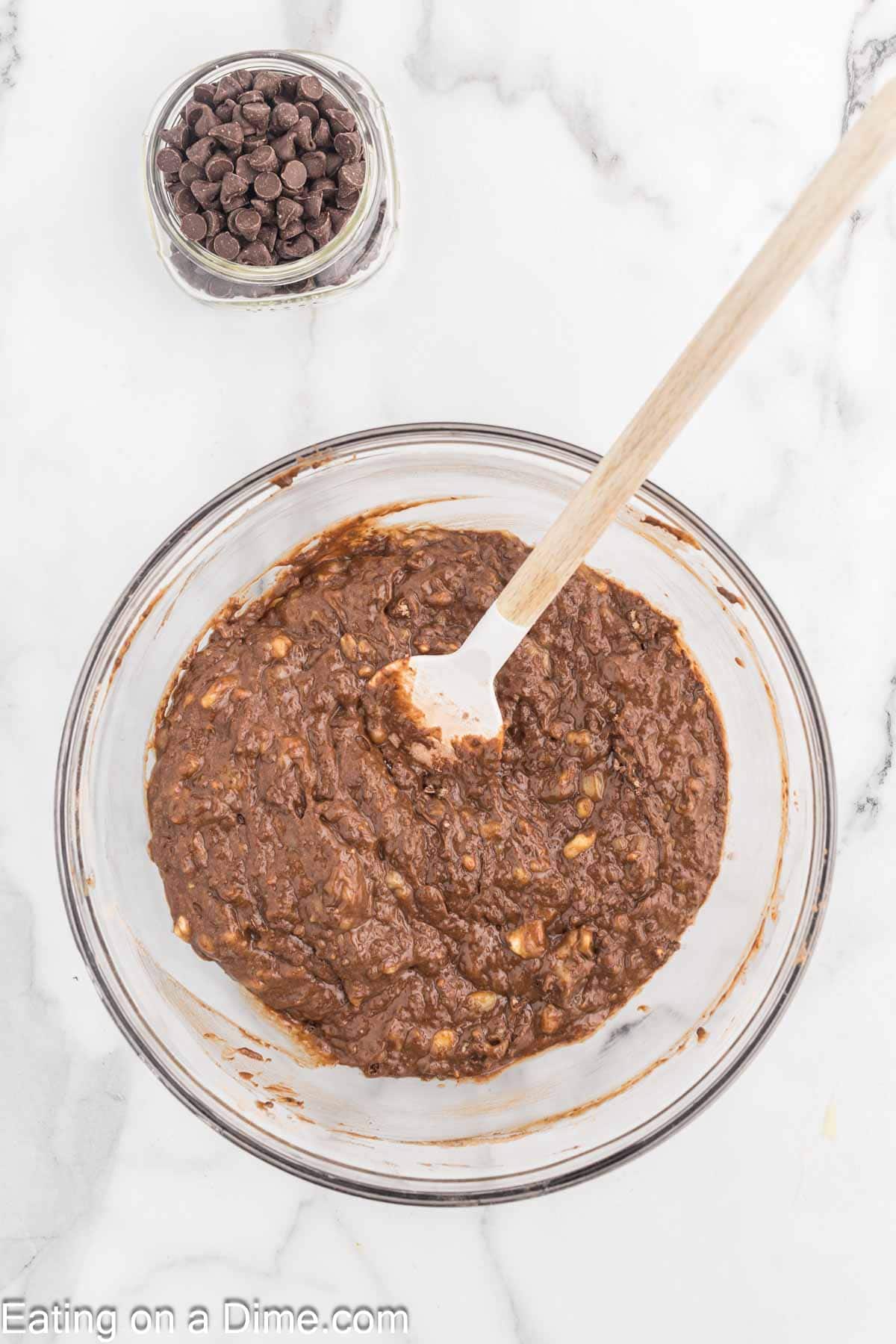 Chocolate banana bread batter in a bowl with a spatula