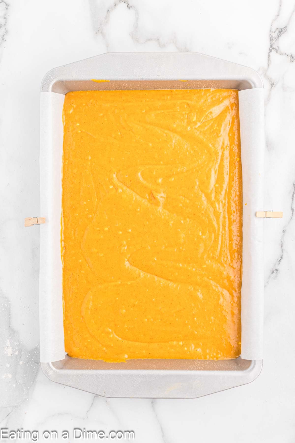 Pouring the pumpkin batter into baking dish