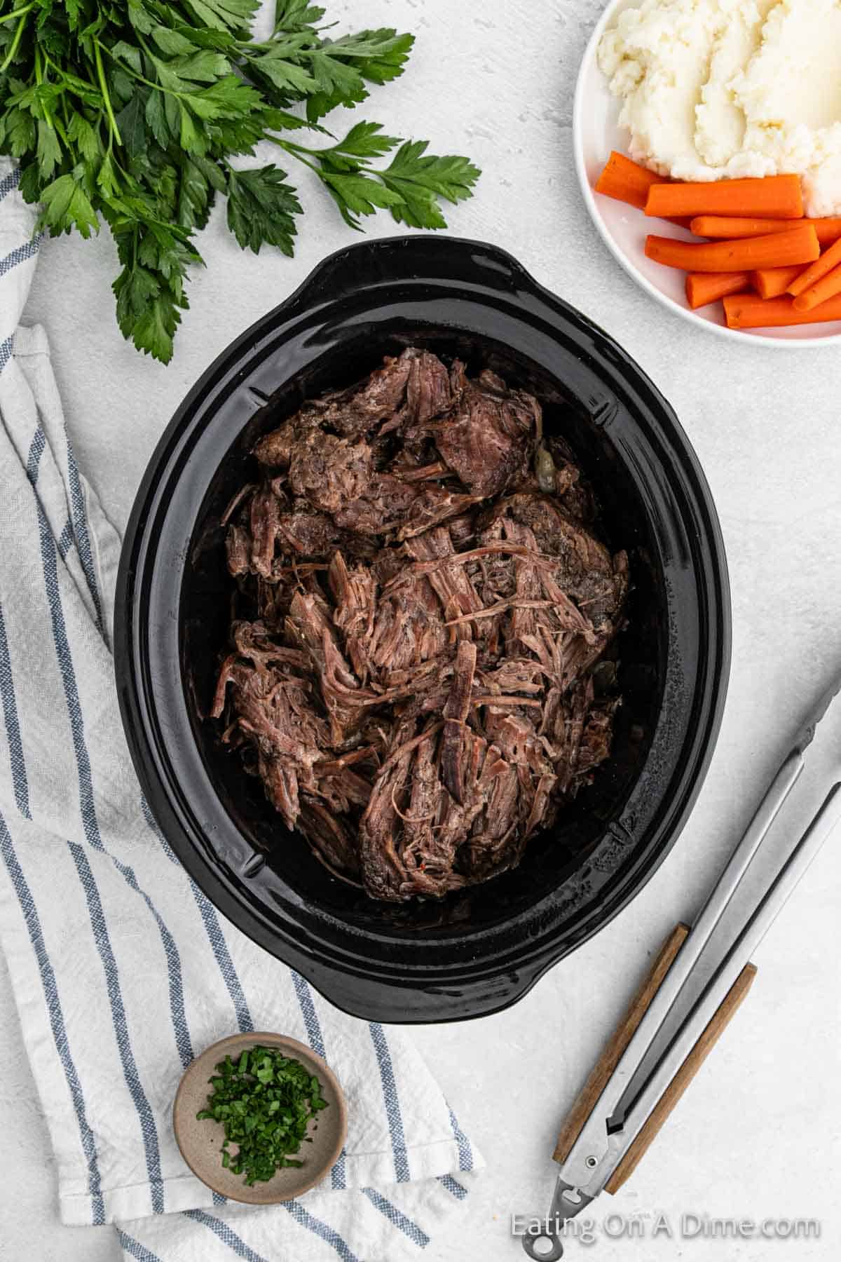 Cooked shredded roast in the slow cooker