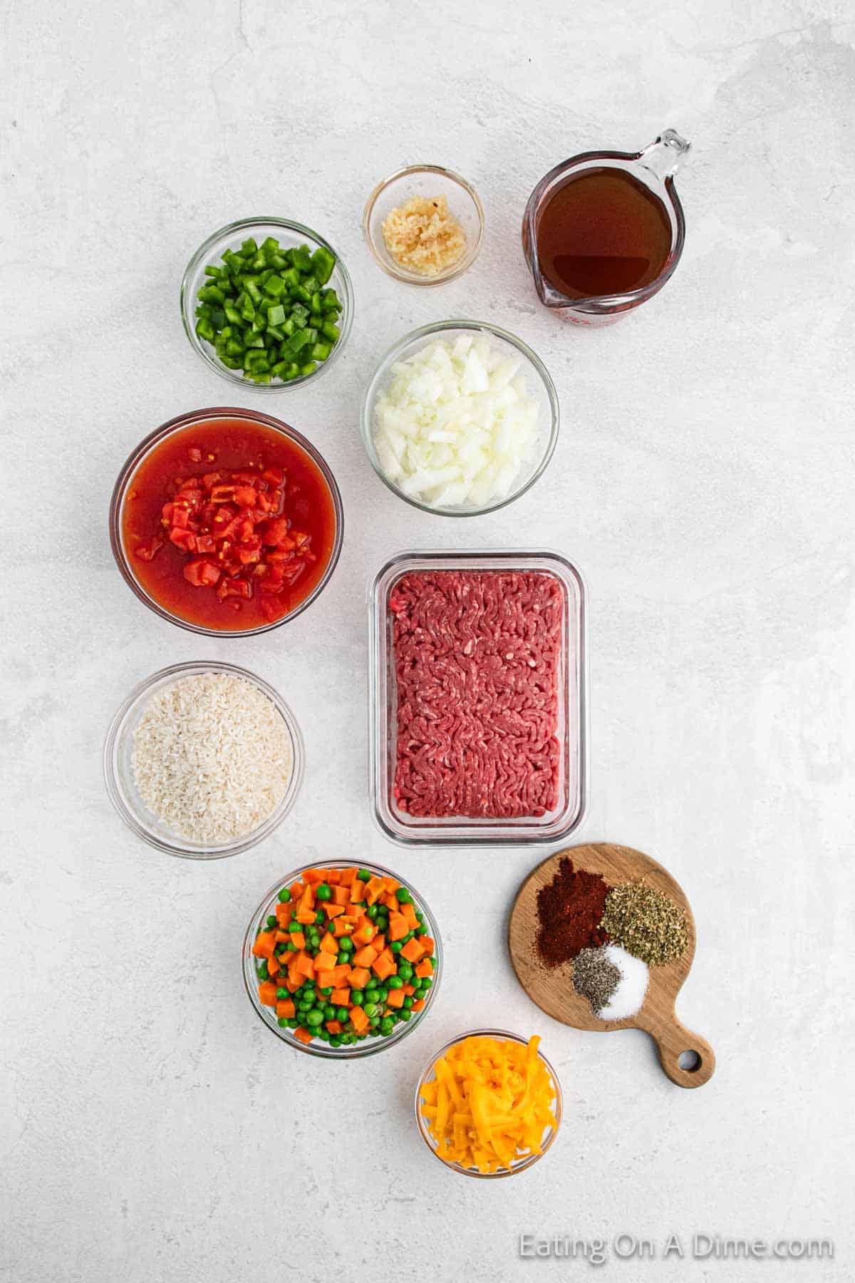 Ingredients - Ground Beef, onion, garlic, bell pepper, white rice, diced tomatoes, beef broth, oregano, paprika, salt, pepper, peas and carrots, cheese, parsley