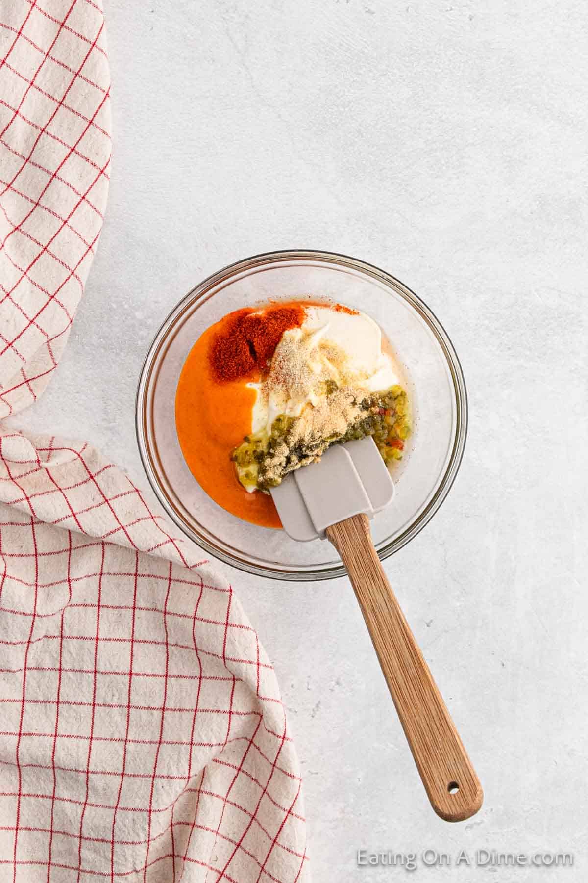 Combining the Big Sauce Ingredients in a bowl with a spatula