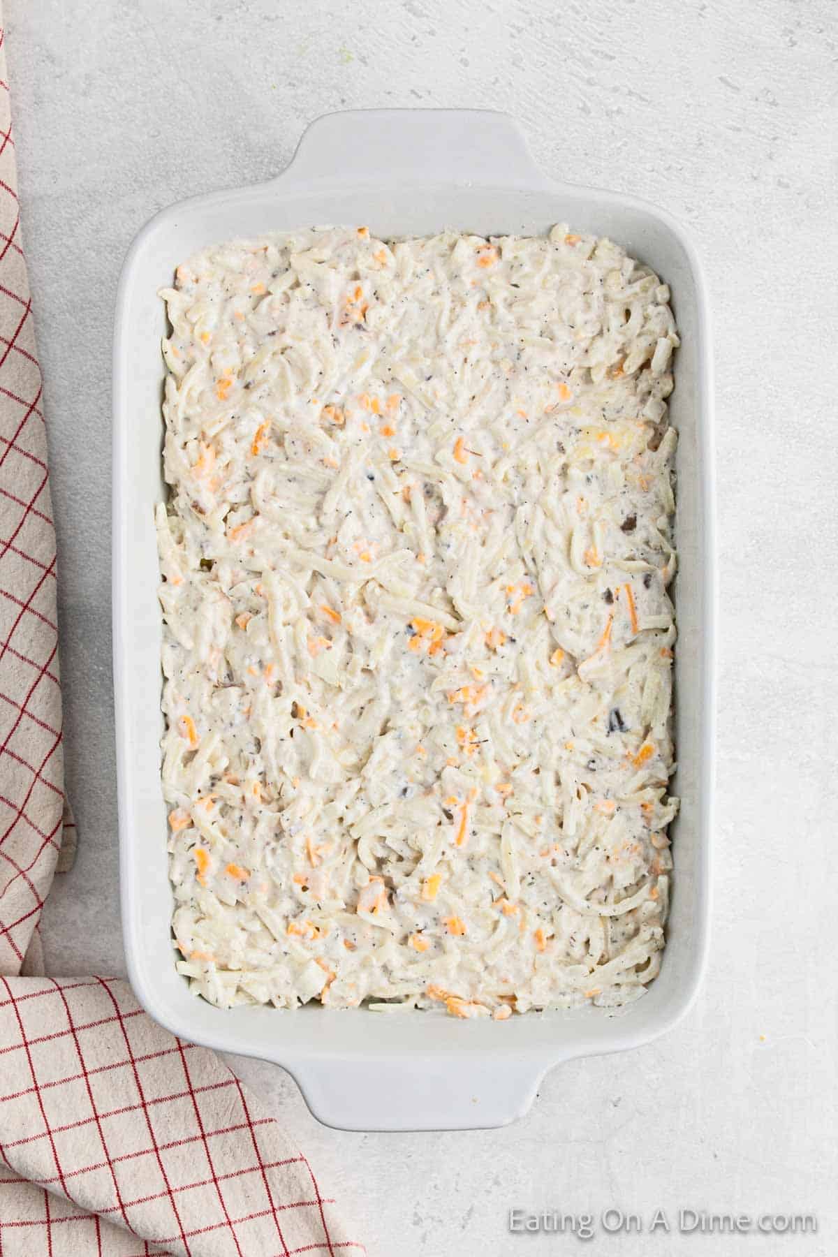 Spreading the hashbrown mixture in a casserole dish