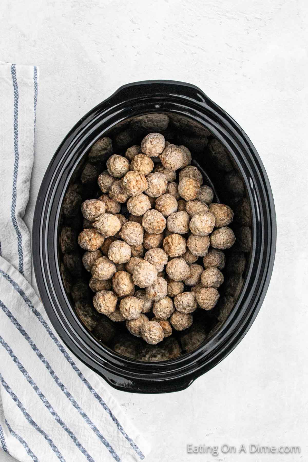 Place frozen meatballs in the slow cooker