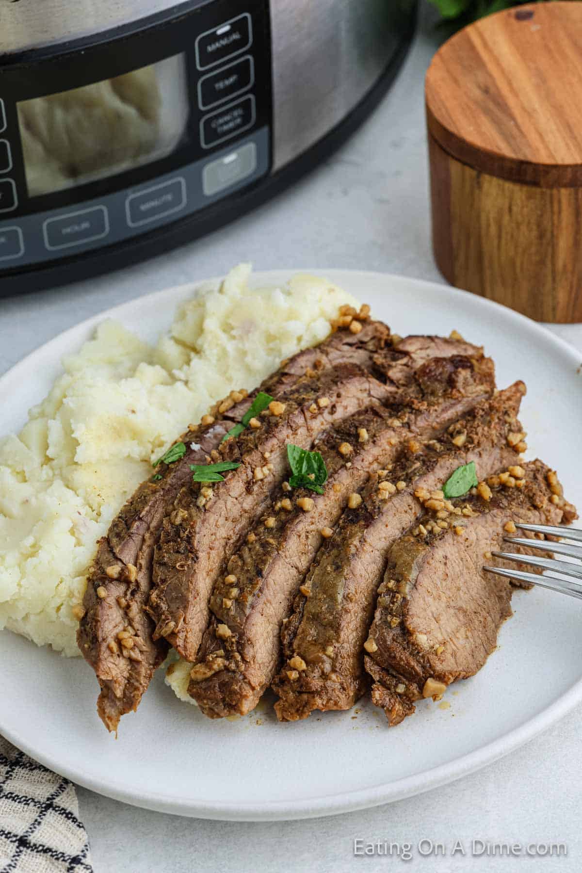 Slice Flank Steak on a plate with mashed potatoes