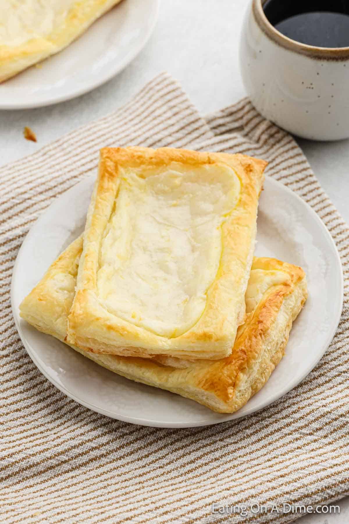 Cheese danish stacked on a plate